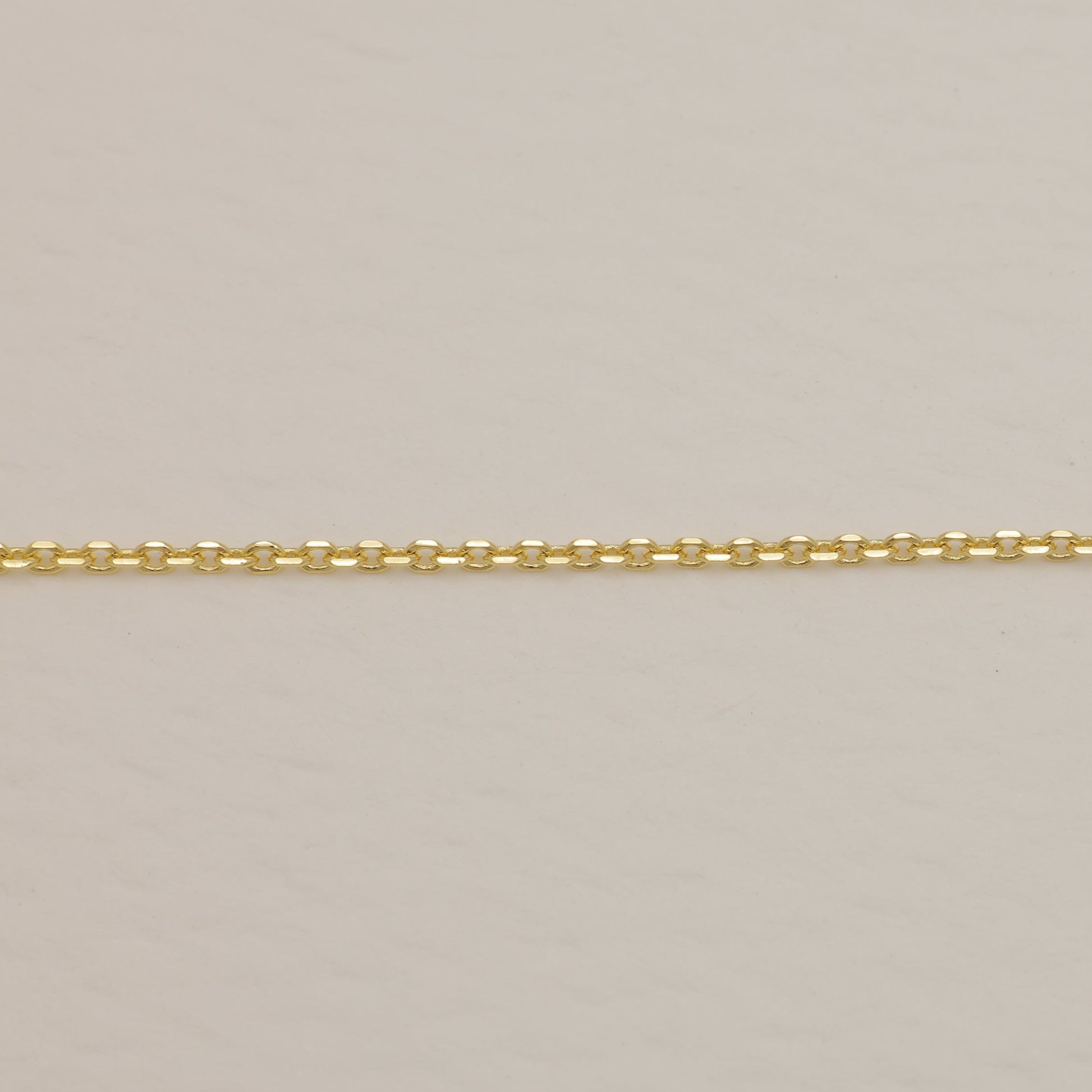 Gold chain on a beige background