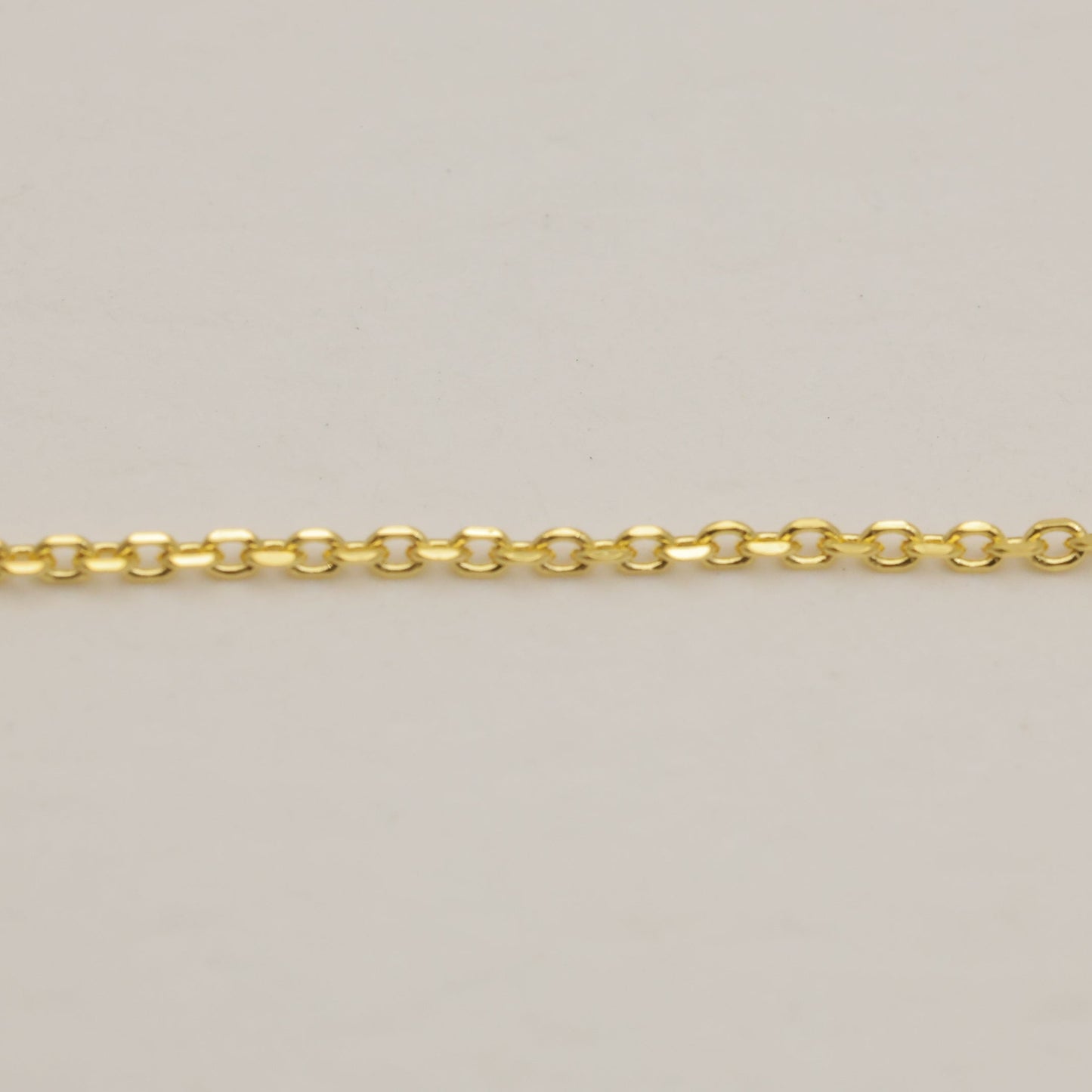 Gold chain on a beige background