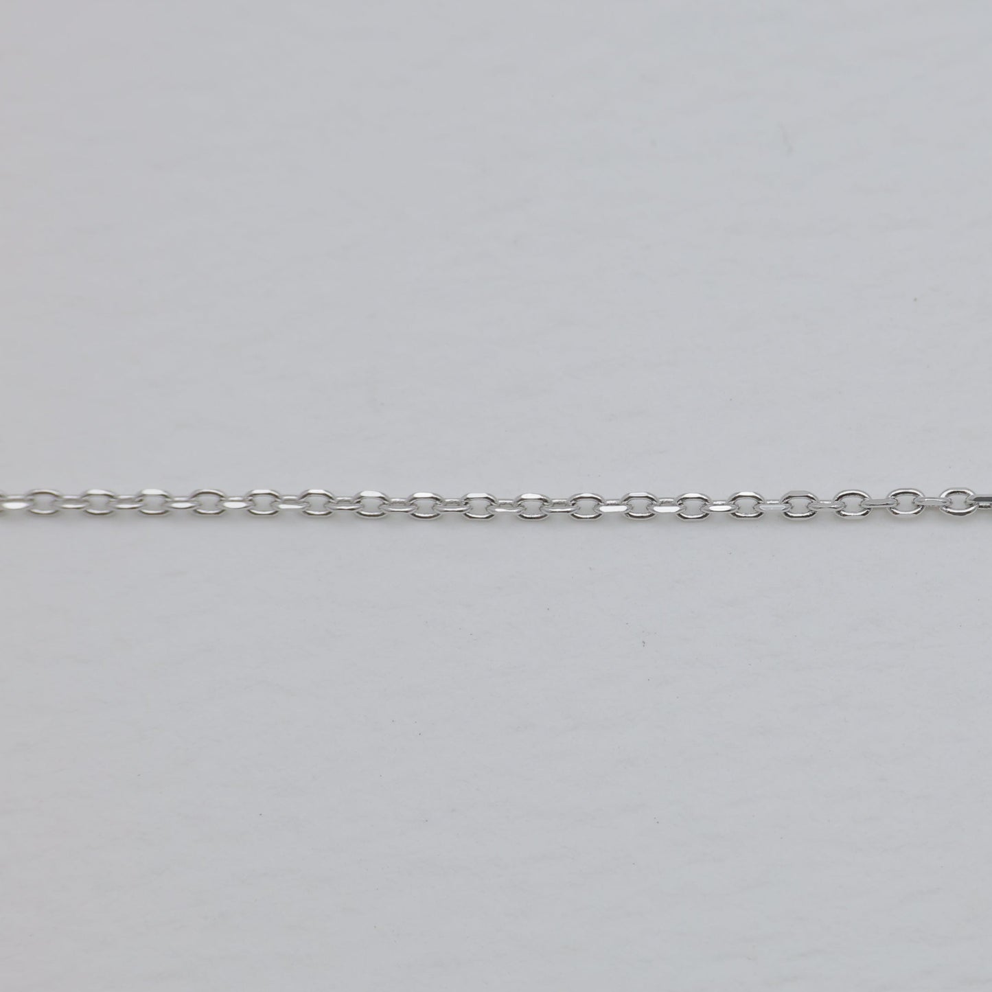 Silver chain on a light gray background