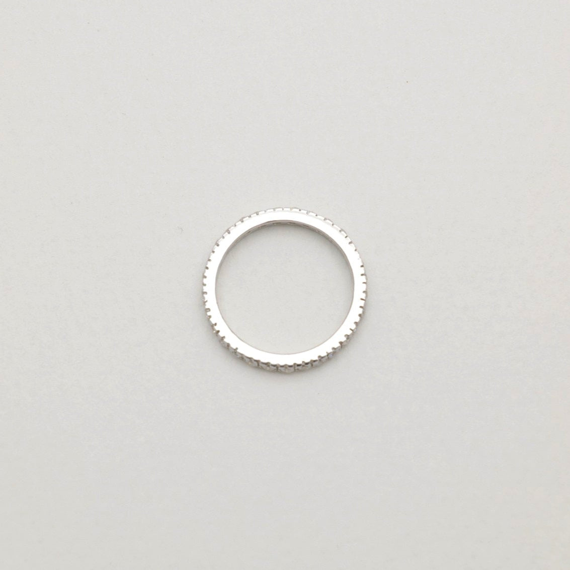 Overhead view of the Aurore Pavé Ring, highlighting its full circular pavé setting and fine polished edges.