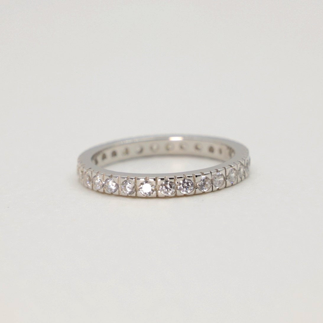 Front view of the Aurore Pavé Ring in sterling silver against a neutral surface.