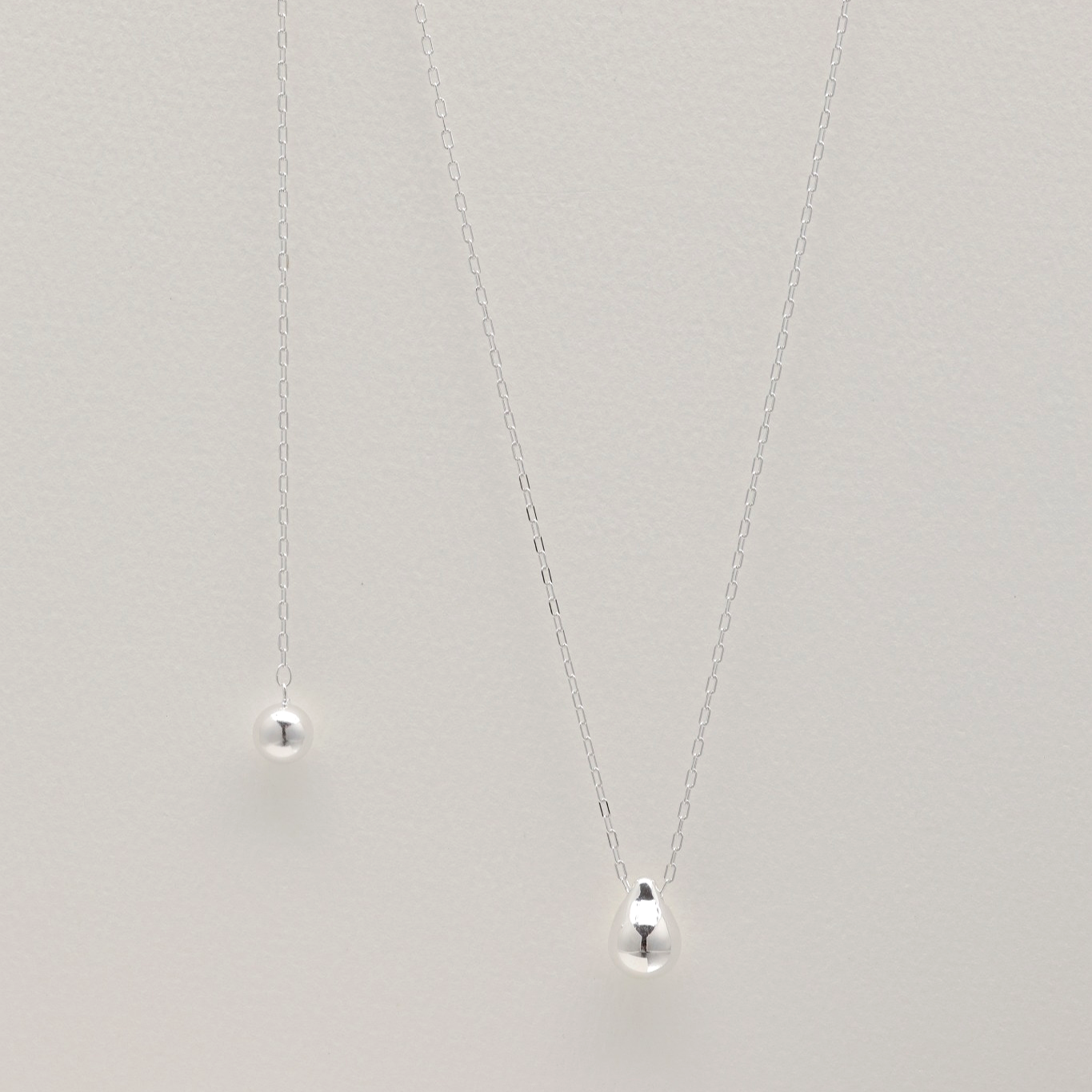 Full-length view of the sterling silver necklace showing adjustable slider and teardrop pendant."