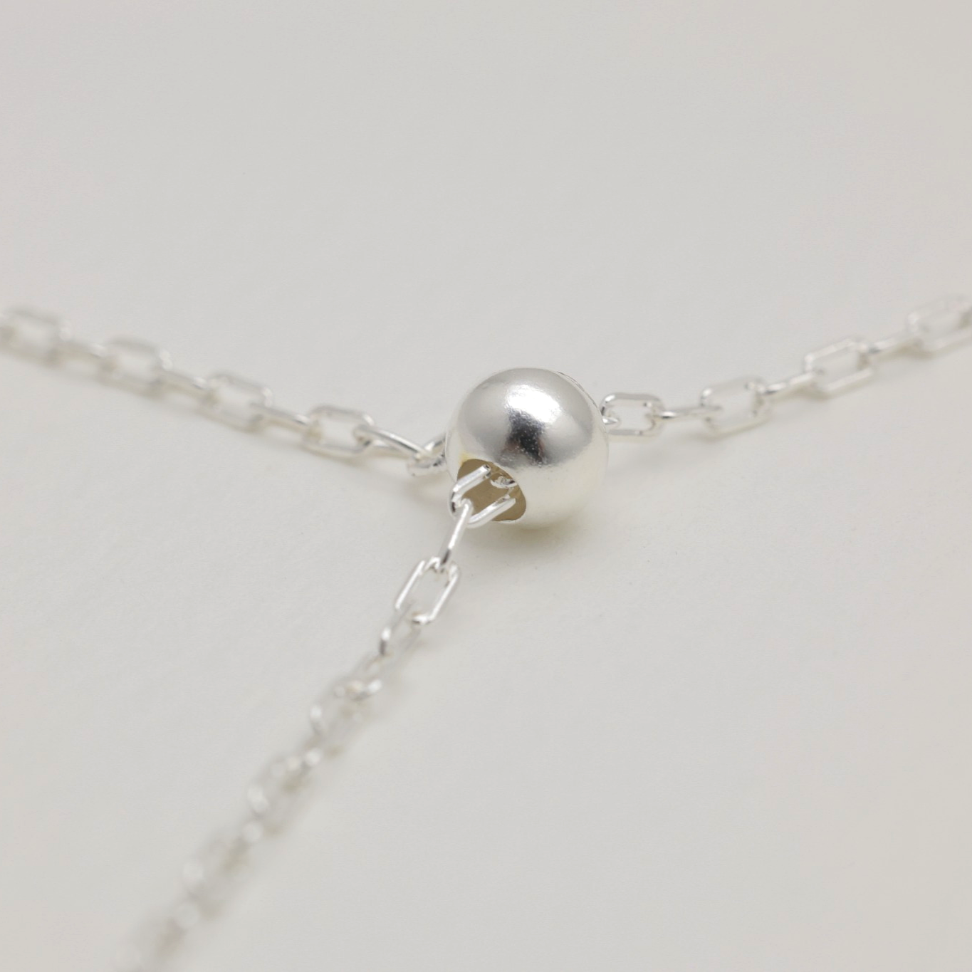 Bead slider clasp detail on sterling silver necklace – allows length adjustment and elegant drape.
