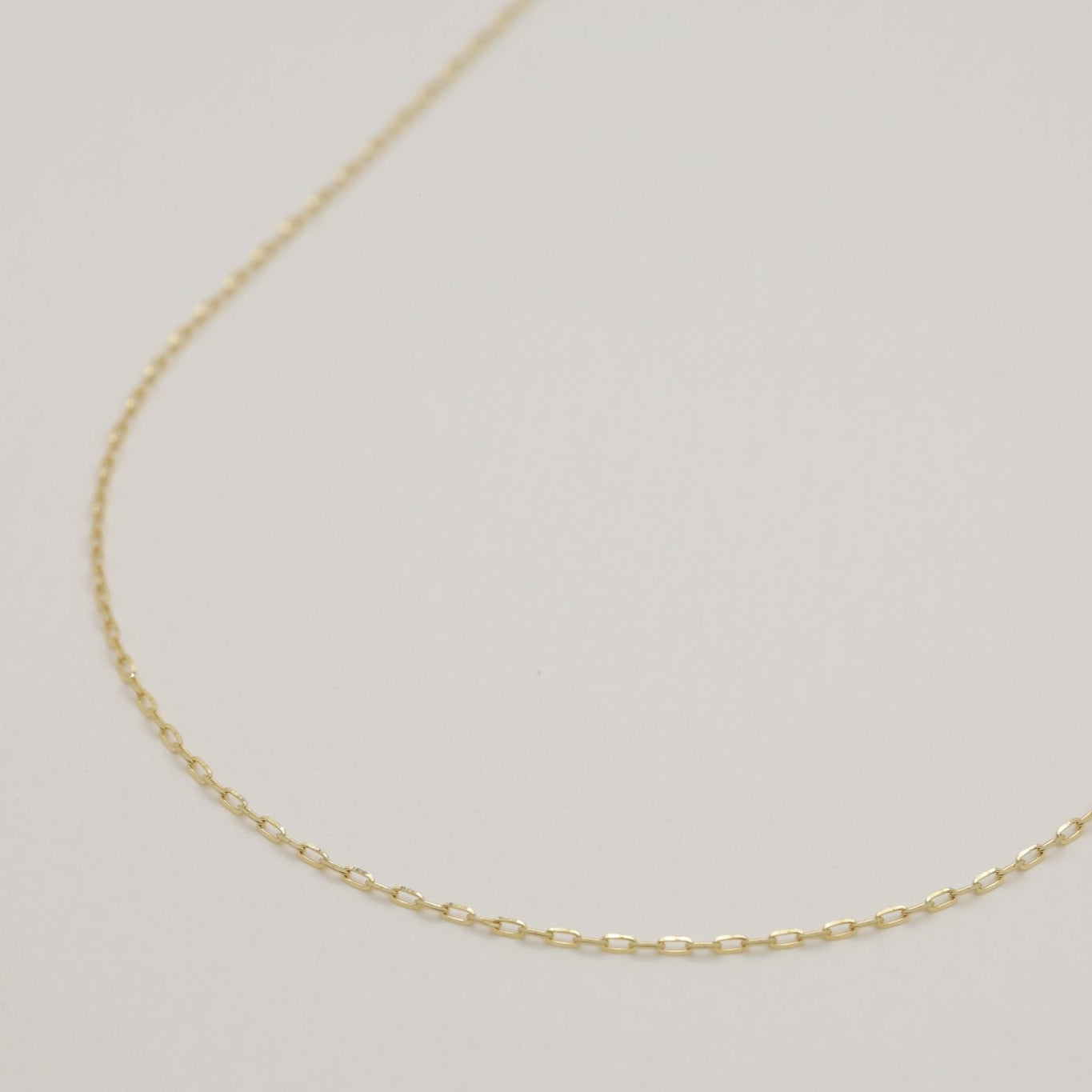 Close-up of 10K gold Aurélie chain necklace showing delicate rectangular links