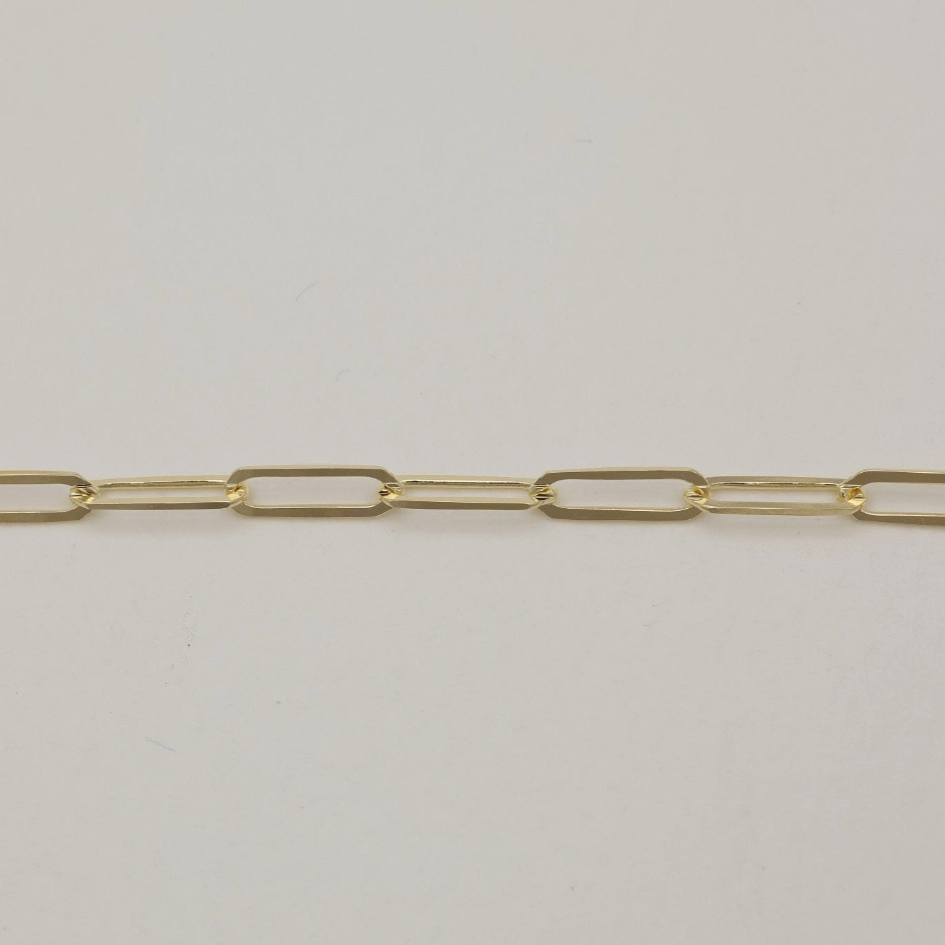 Close-up of rectangular paperclip-style links on the Clara Bracelet in 14K gold.