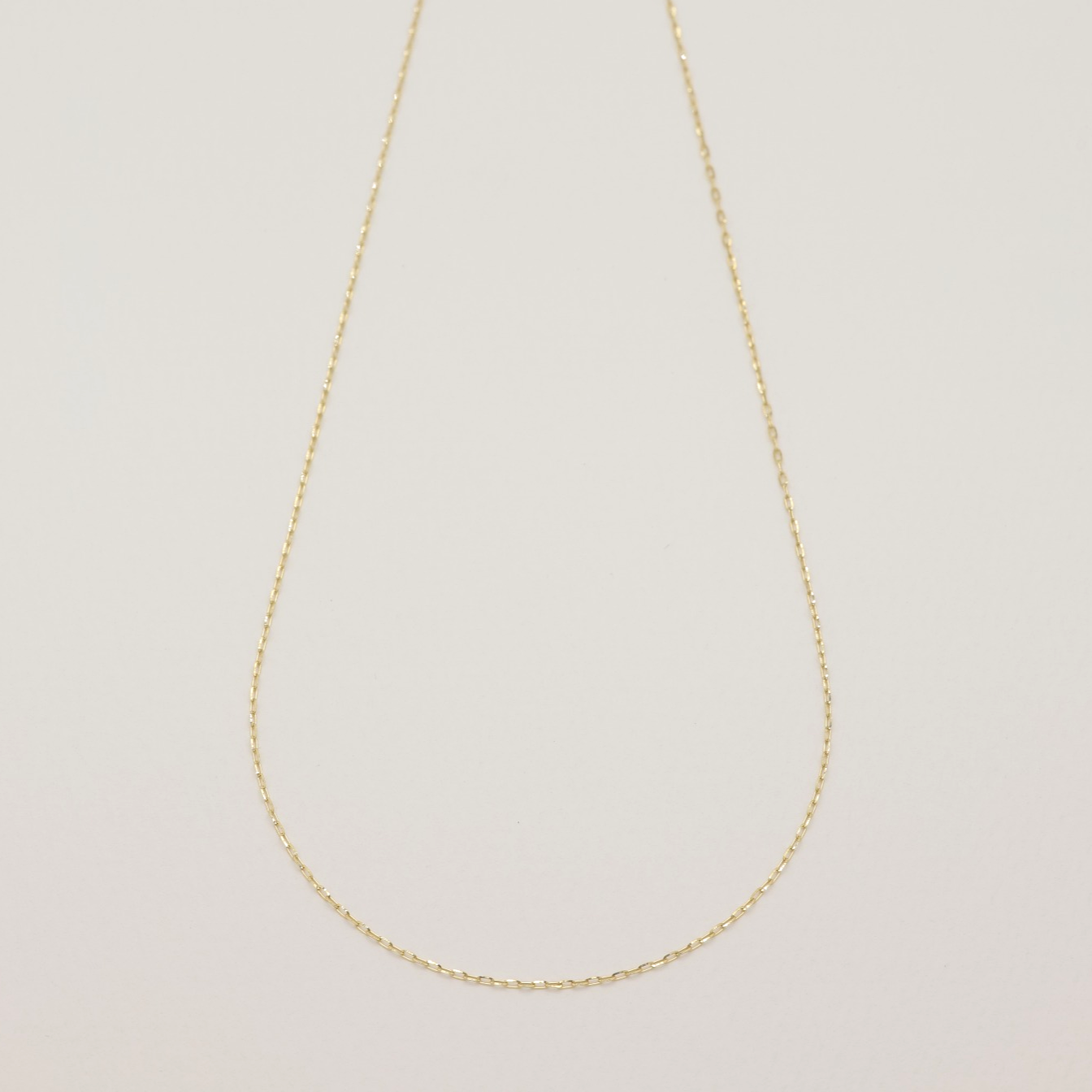 Full view of delicate 10K gold chain necklace with extender clasp, 45cm length