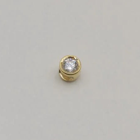 14K gold charm with bezel-set lab-grown diamond on cream background, photographed from front and side angles.