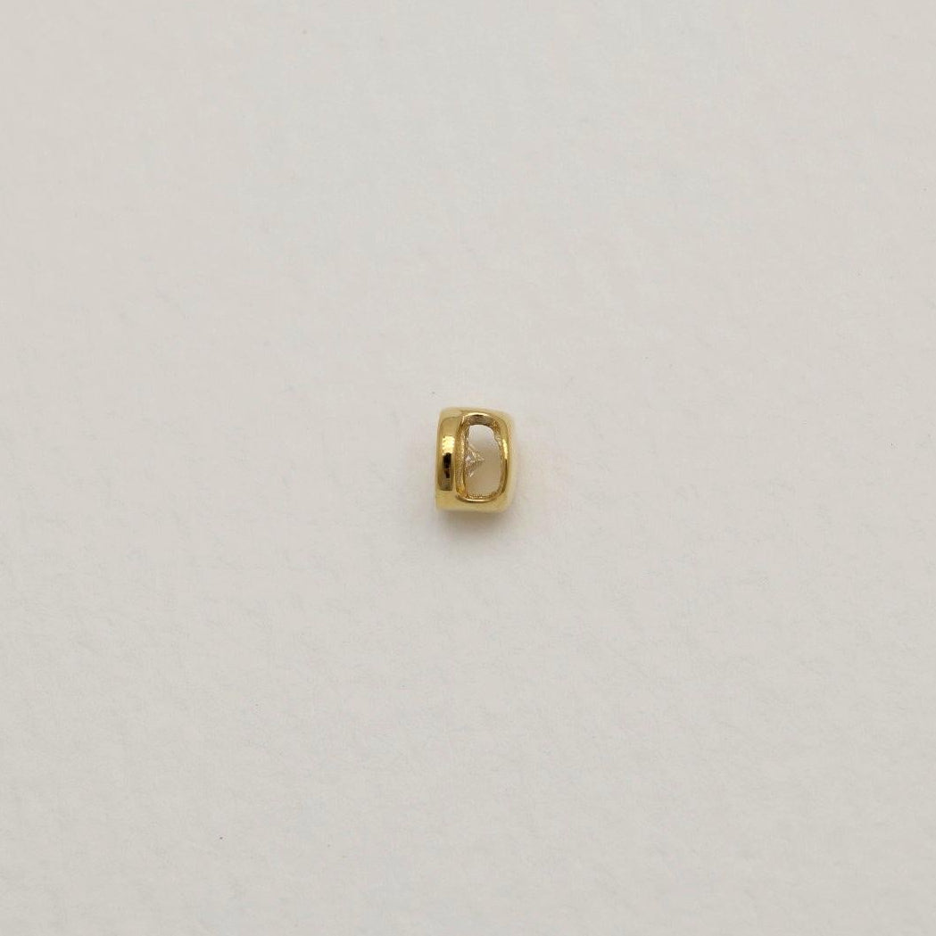 14K gold charm with bezel-set lab-grown diamond on cream background, photographed from front and side angles.