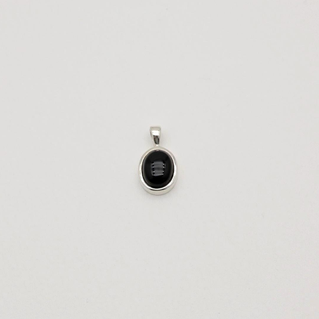 Sterling silver pendant with black onyx stone in a round bezel setting. Clean, minimal, and elegant.