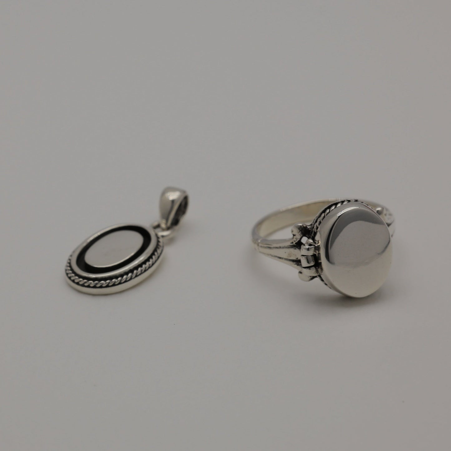 Sterling silver oval pendant with polished centre and oxidized rope edge, shown alone and styled with matching Séraphine ring.