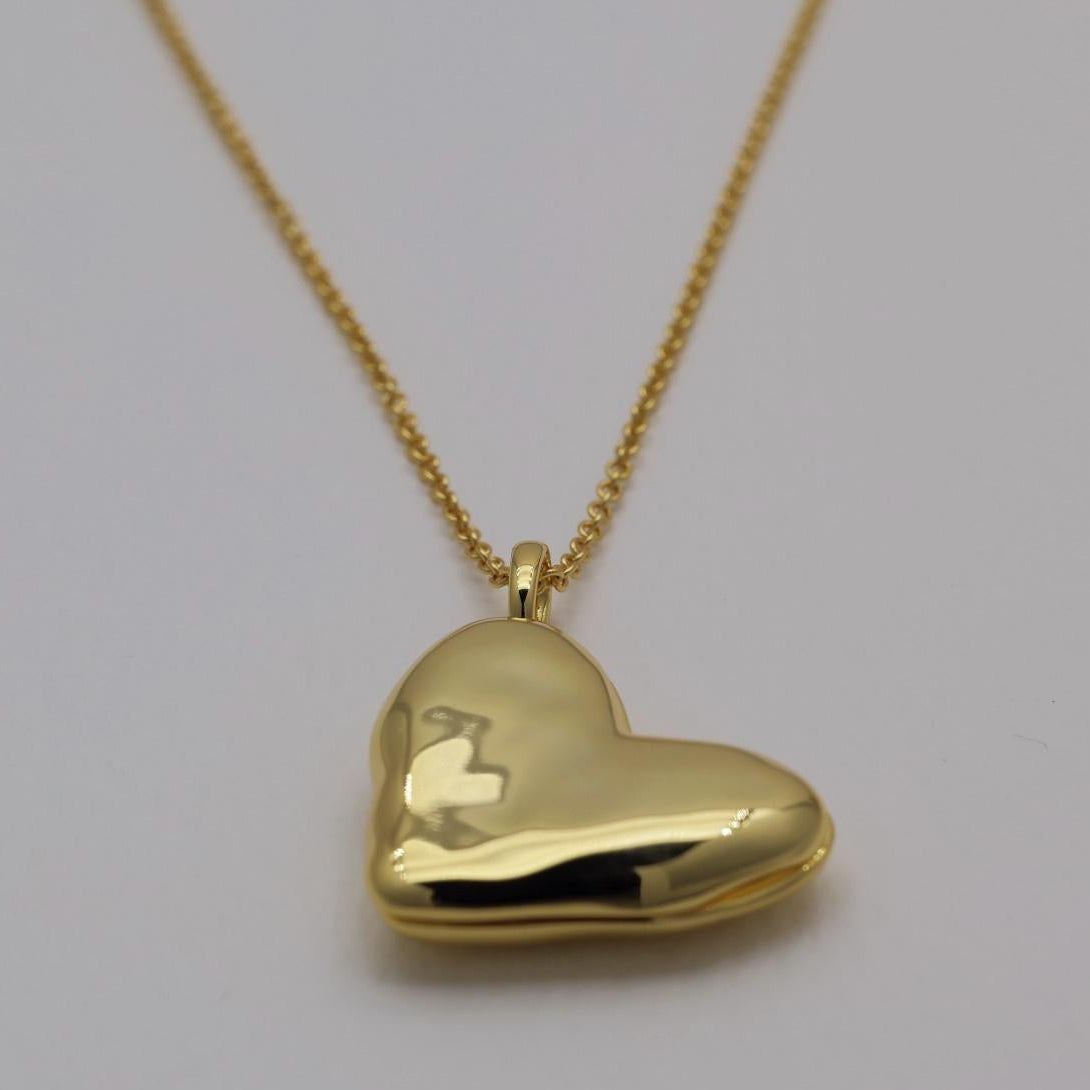 Gold vermeil heart locket necklace with polished finish, photographed open and closed on a plain background.