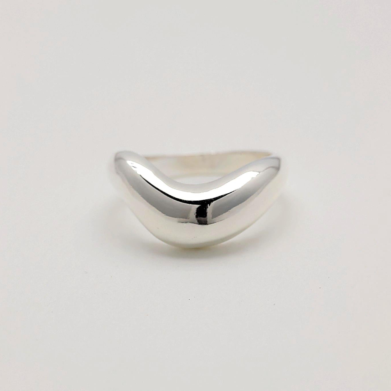 Front view of a polished sterling silver ring featuring a contoured, organic shape that reflects light elegantly.
