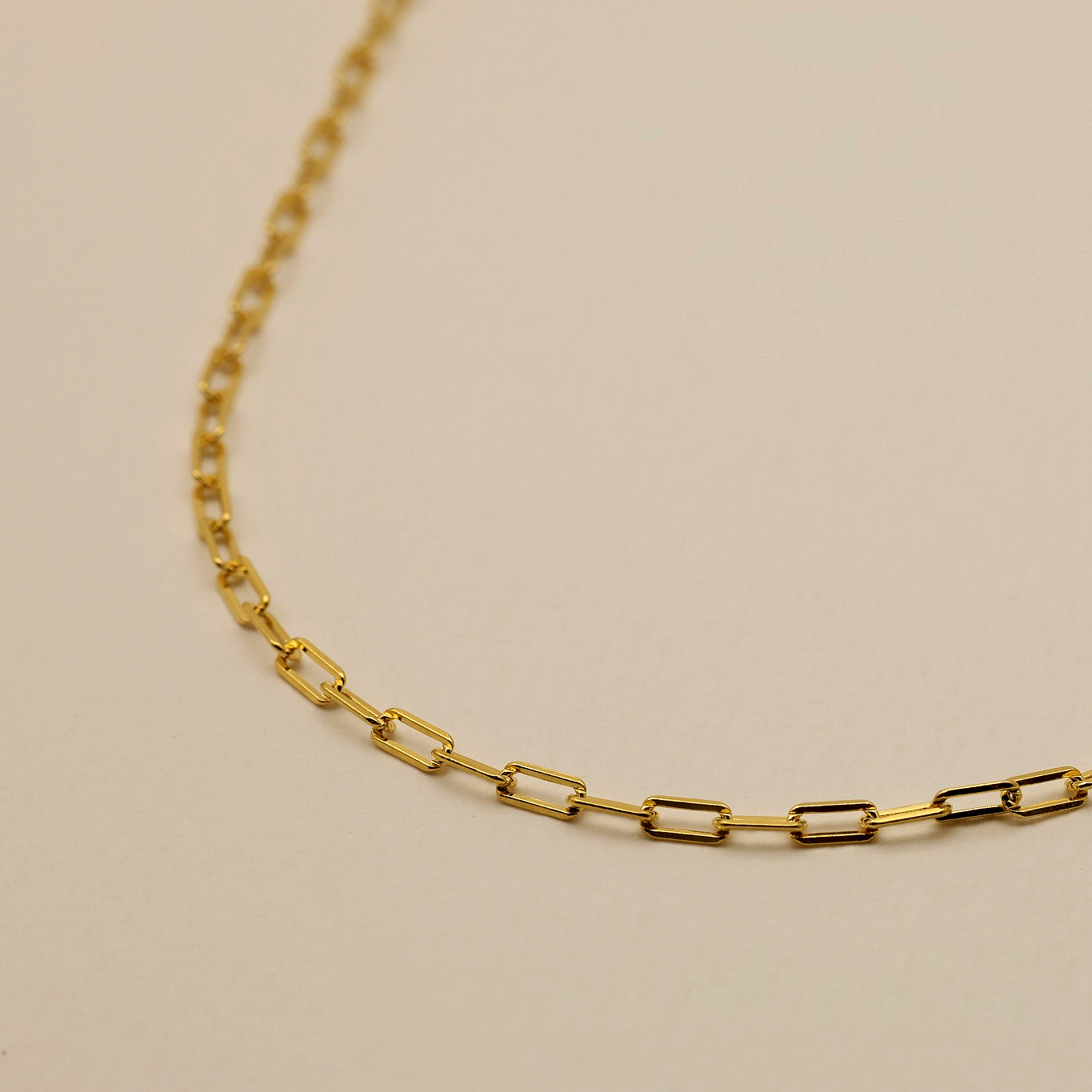 Close-up of rectangular link chain necklace in polished 18K gold vermeil
