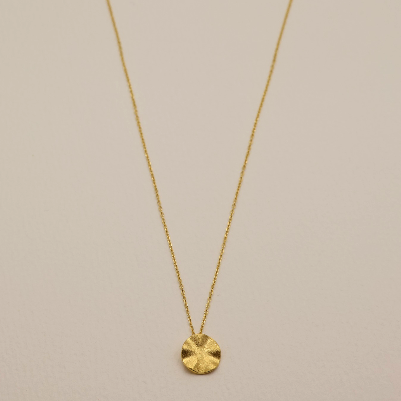 Full view of the Éline Necklace laid flat, highlighting the subtle ripple texture and extension chain.
