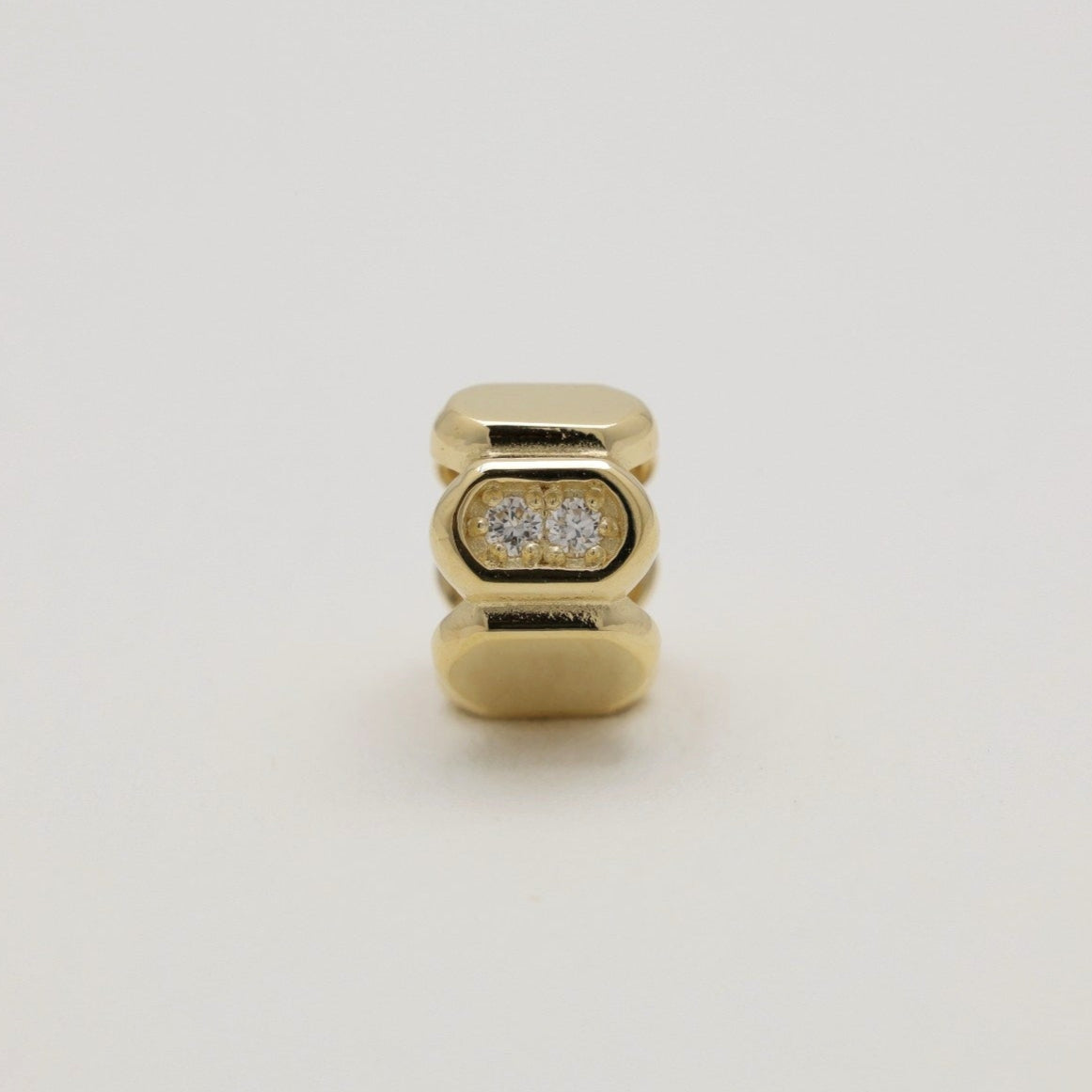 Orielle 14K gold pavé pendant standing upright on neutral background