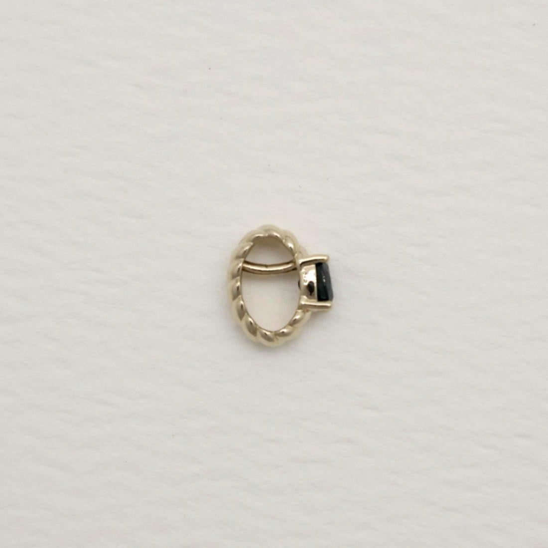 14K white gold charm pendant featuring an oval-cut sapphire with twisted detailing
