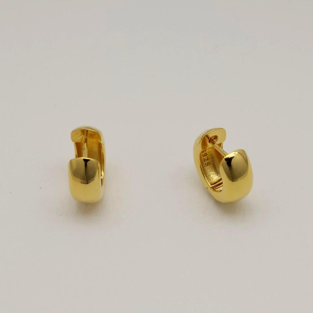 Polished gold vermeil mini hoop earrings with a smooth rounded finish, crafted in Korea.