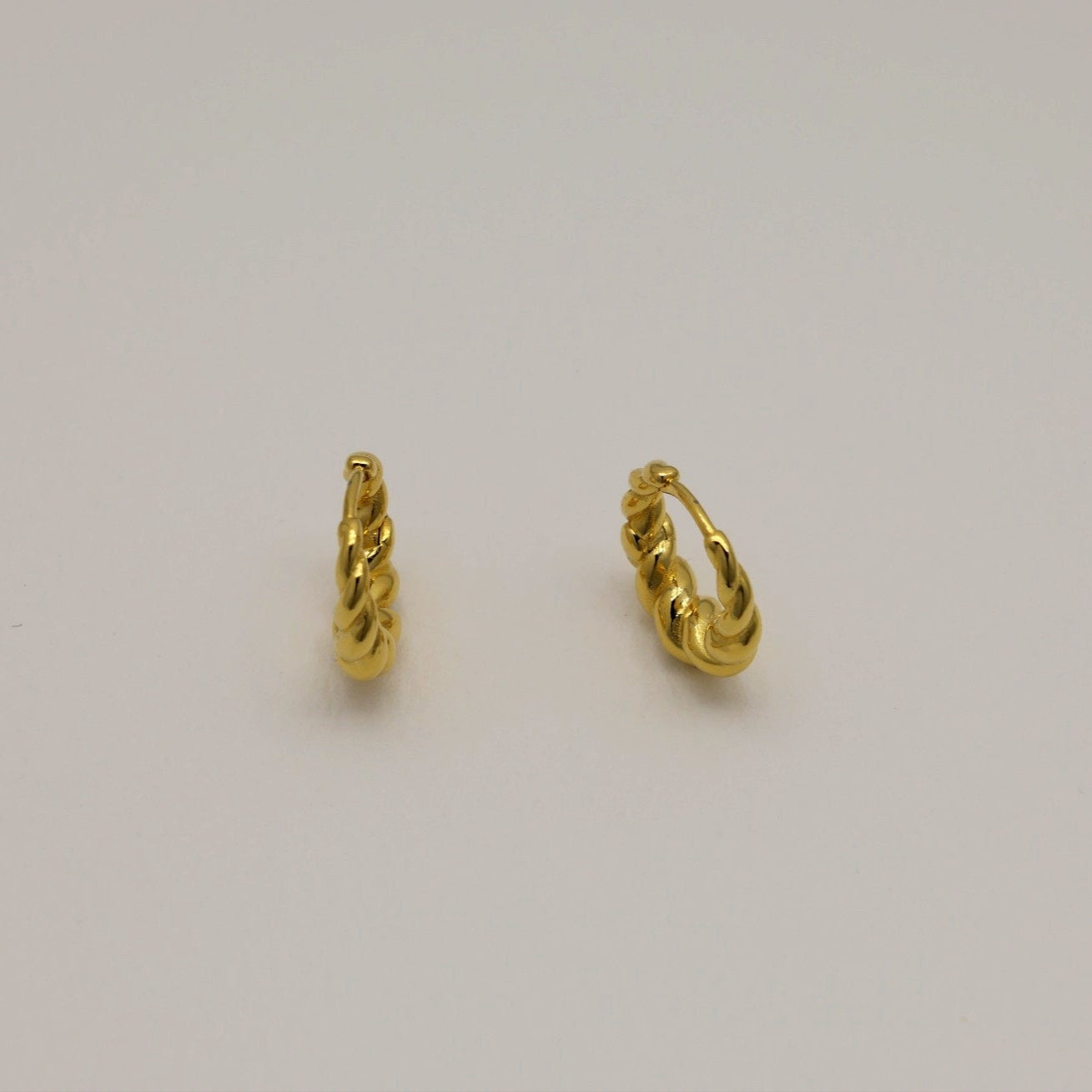 Matte gold vermeil rope twist mini hoop earrings with hinge closure, displayed on neutral background.