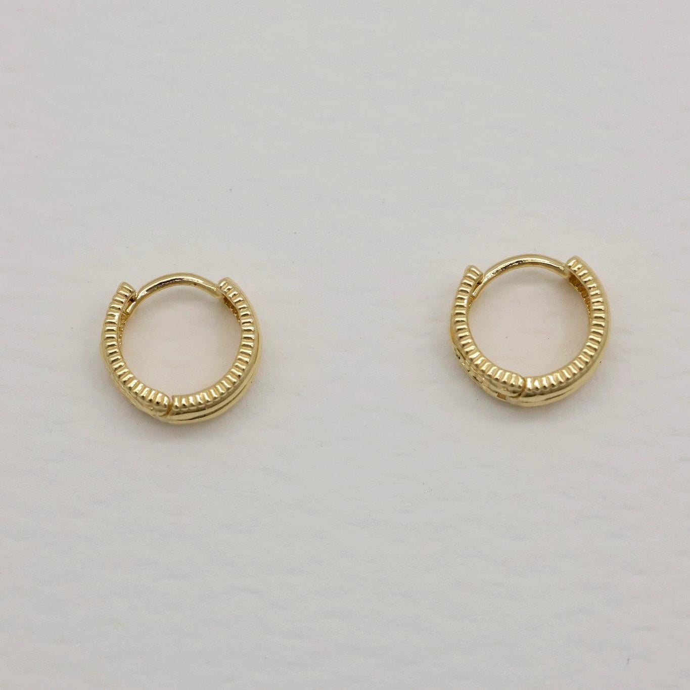 14K gold small hoop earrings with ribbed texture, front and side view on neutral background