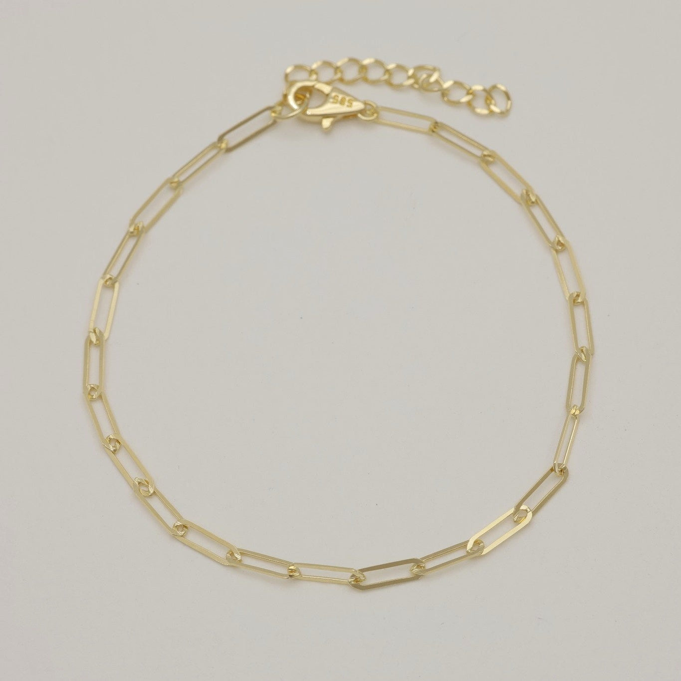 Full bracelet image of the Inès design in 14K gold with extension chain and clasp.