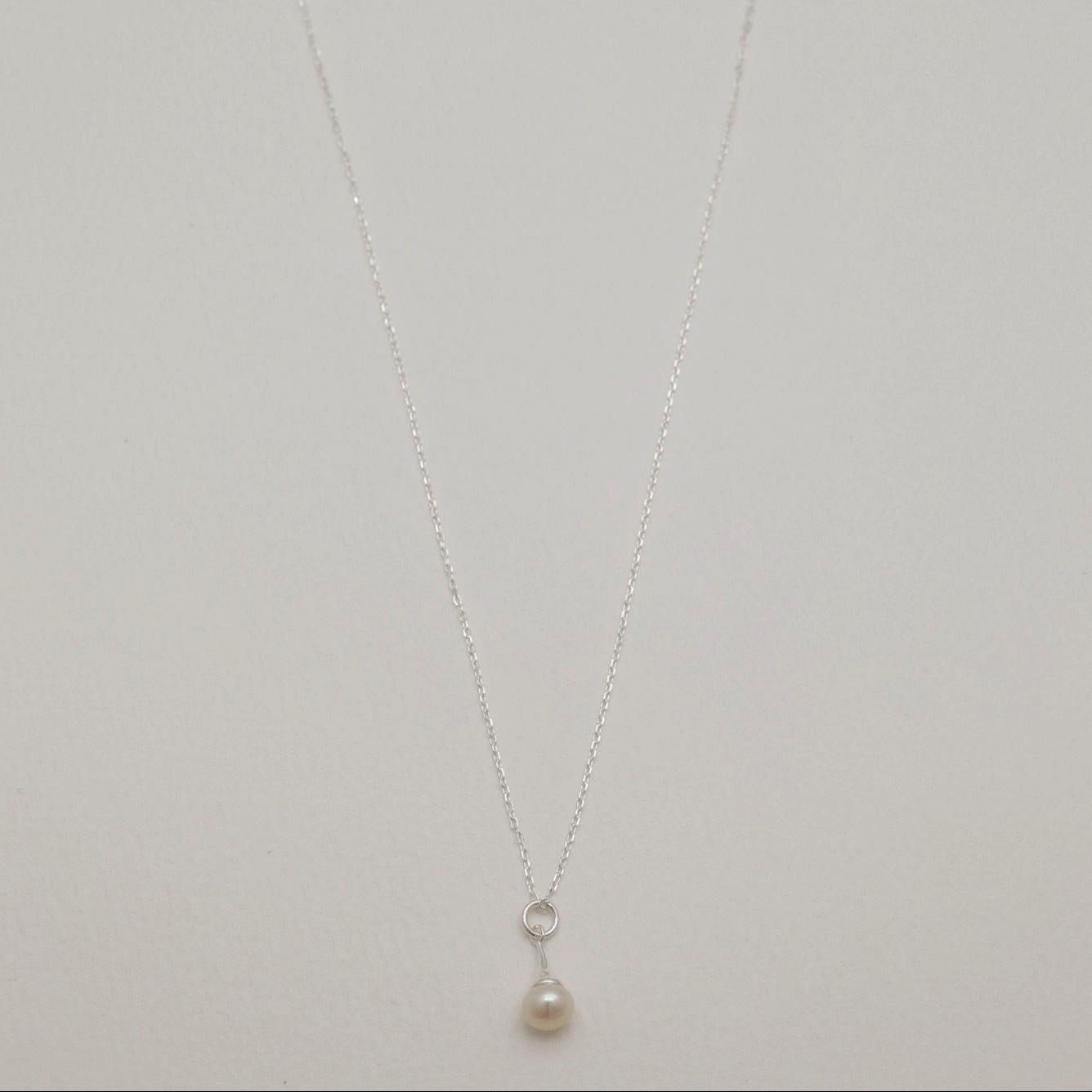 Full view of the Léa Necklace featuring a single natural pearl pendant on a 925 sterling silver chain.