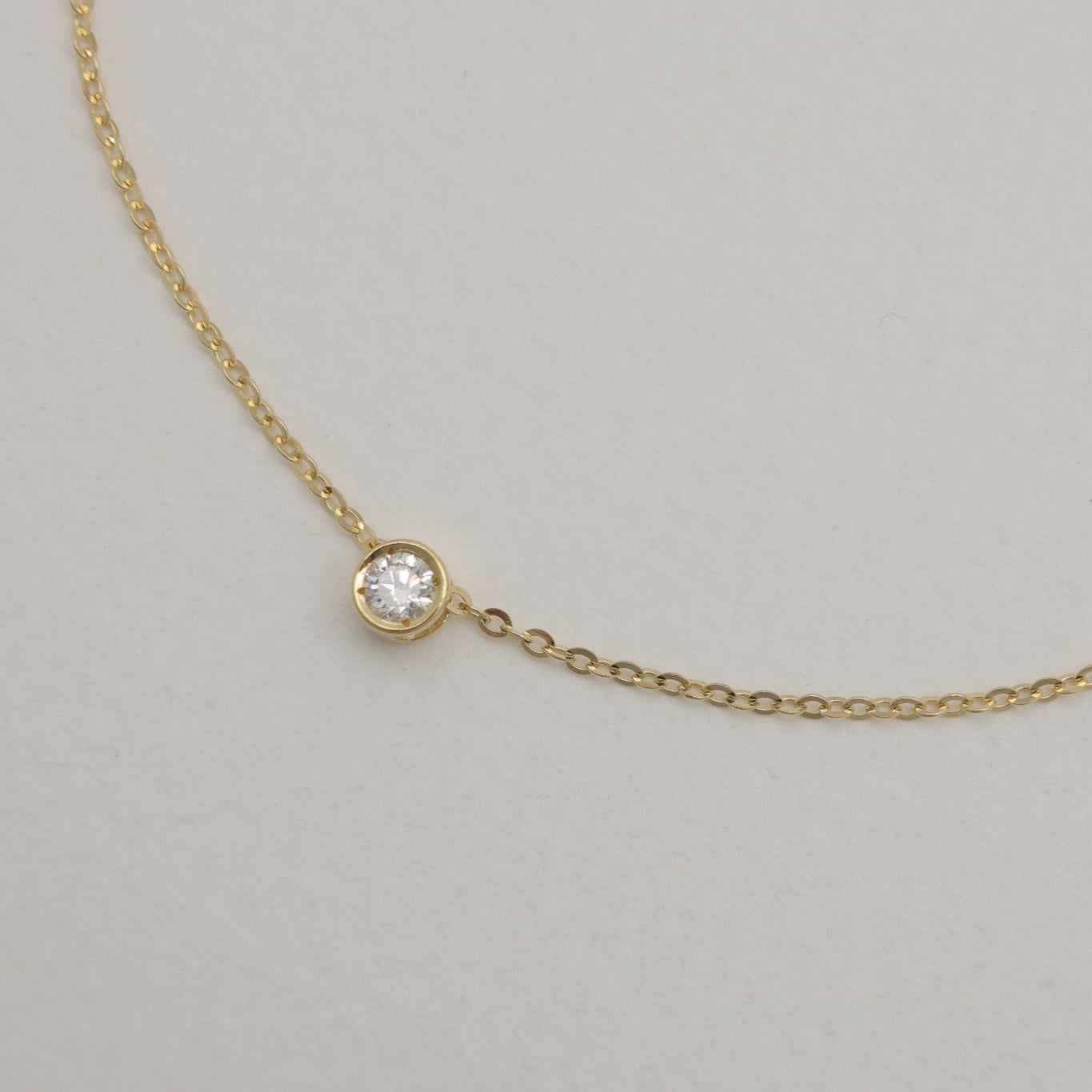 Close-up of lab-grown diamond in bezel setting on 14K gold chain