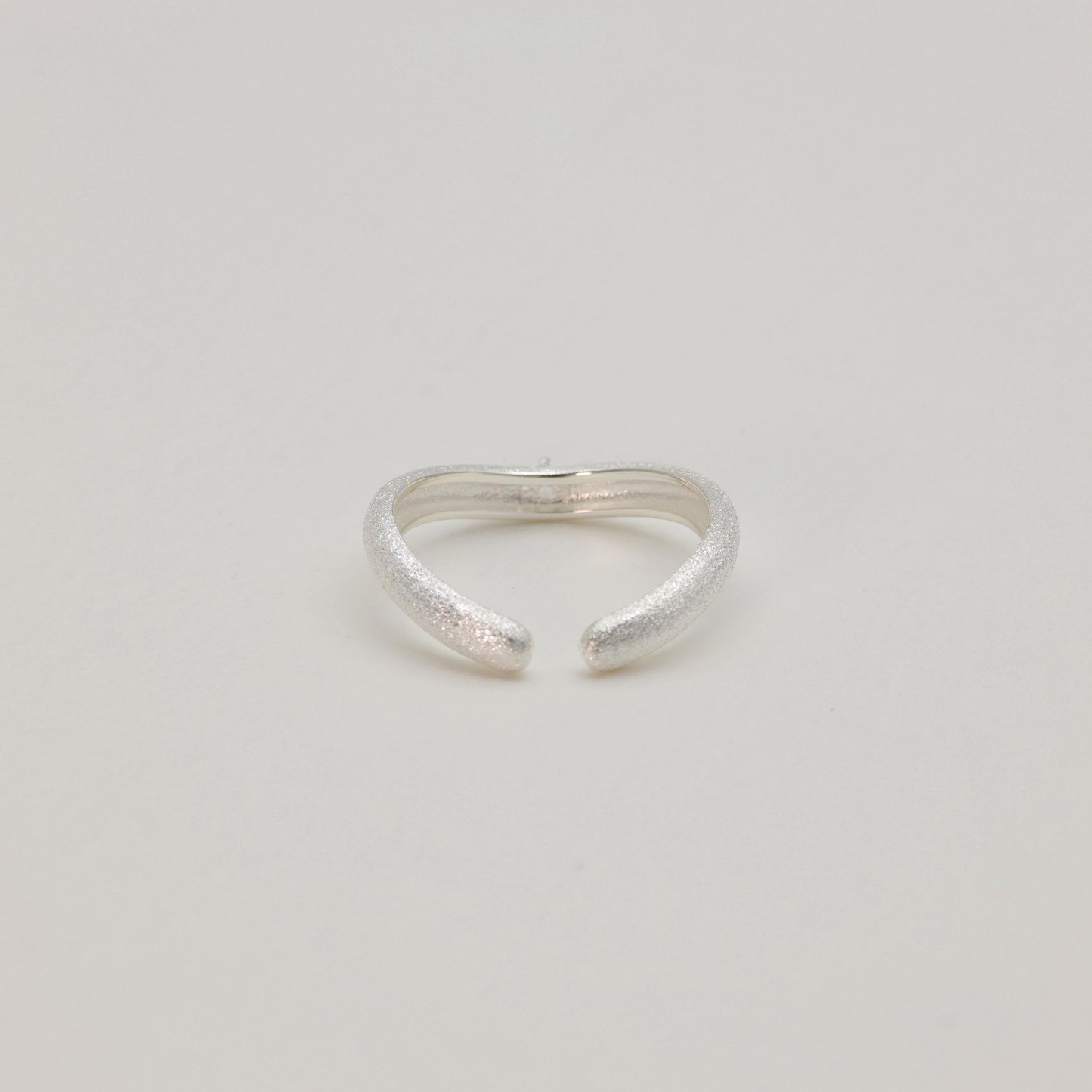 Back view of sculpted dome ring in natural light