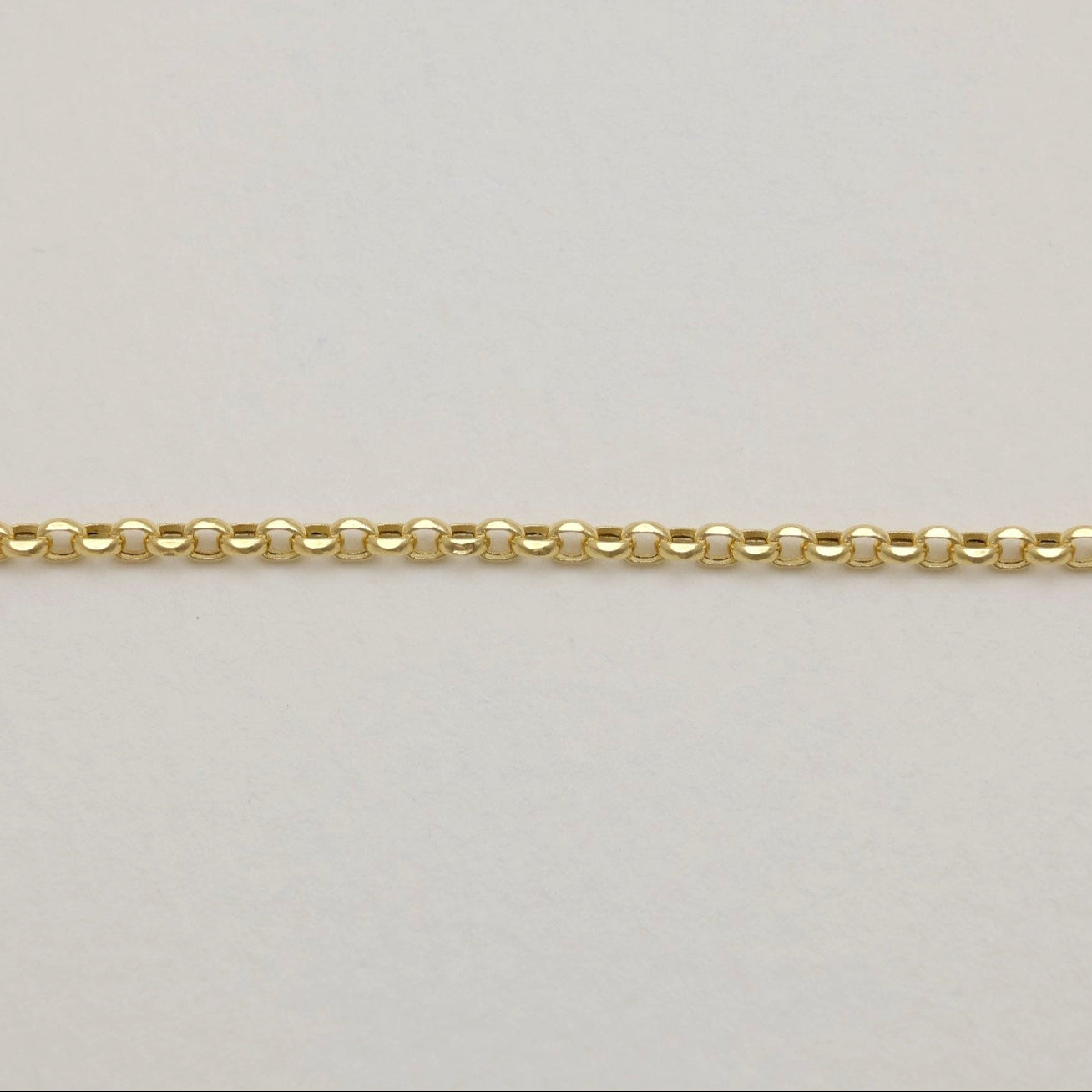 Side view of polished gold links in Claude Chain Bracelet