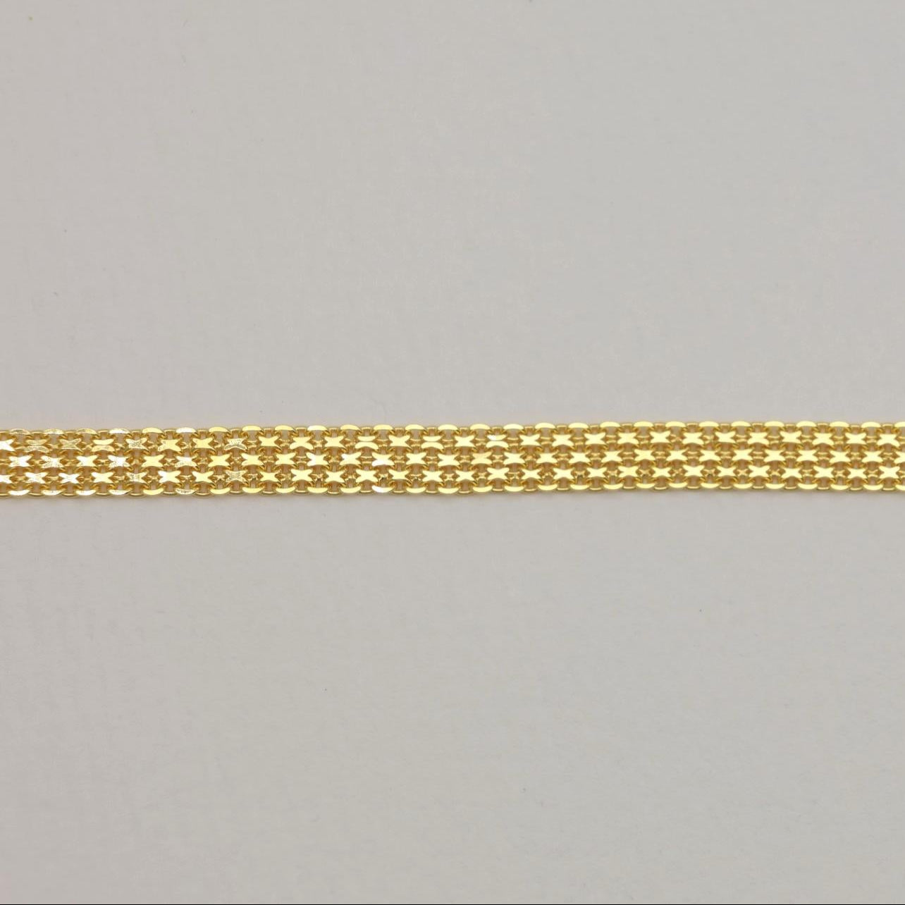 Close-up detail of gold mesh texture with soft polish.