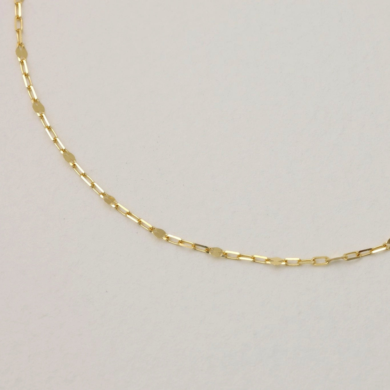 Gleaming 18K gold chain detail with fine links