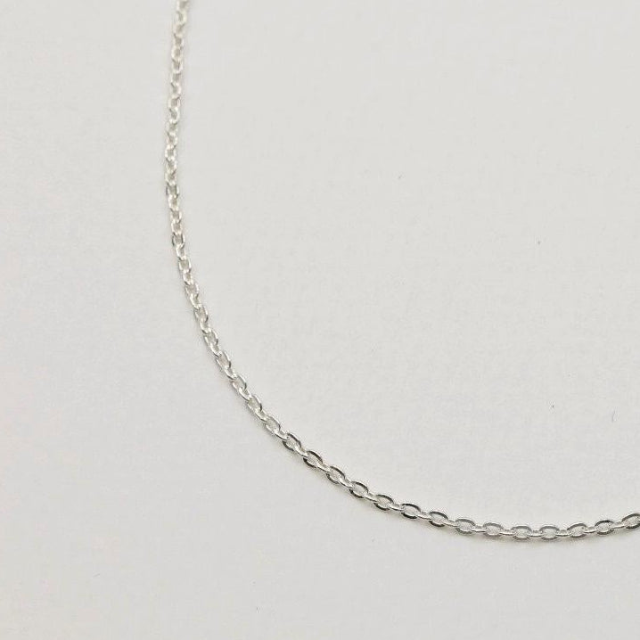 925 sterling silver fine chain necklace, 42cm, shown on neutral background with polished finish and oval links.