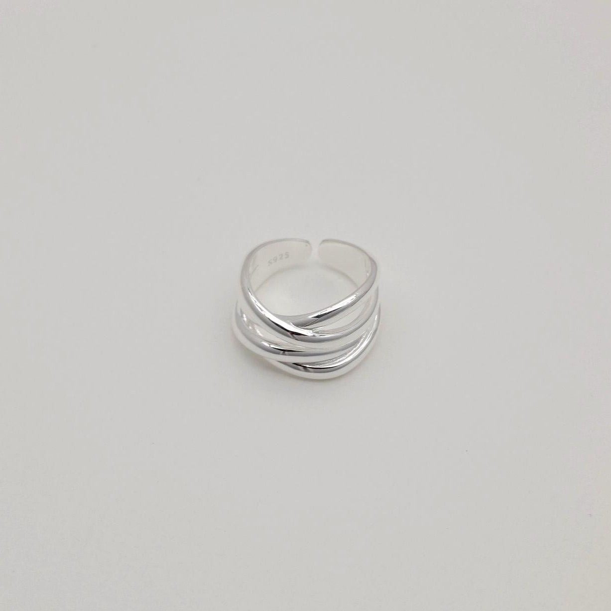 "MOA silver ring with adjustable open back and overlapping design"