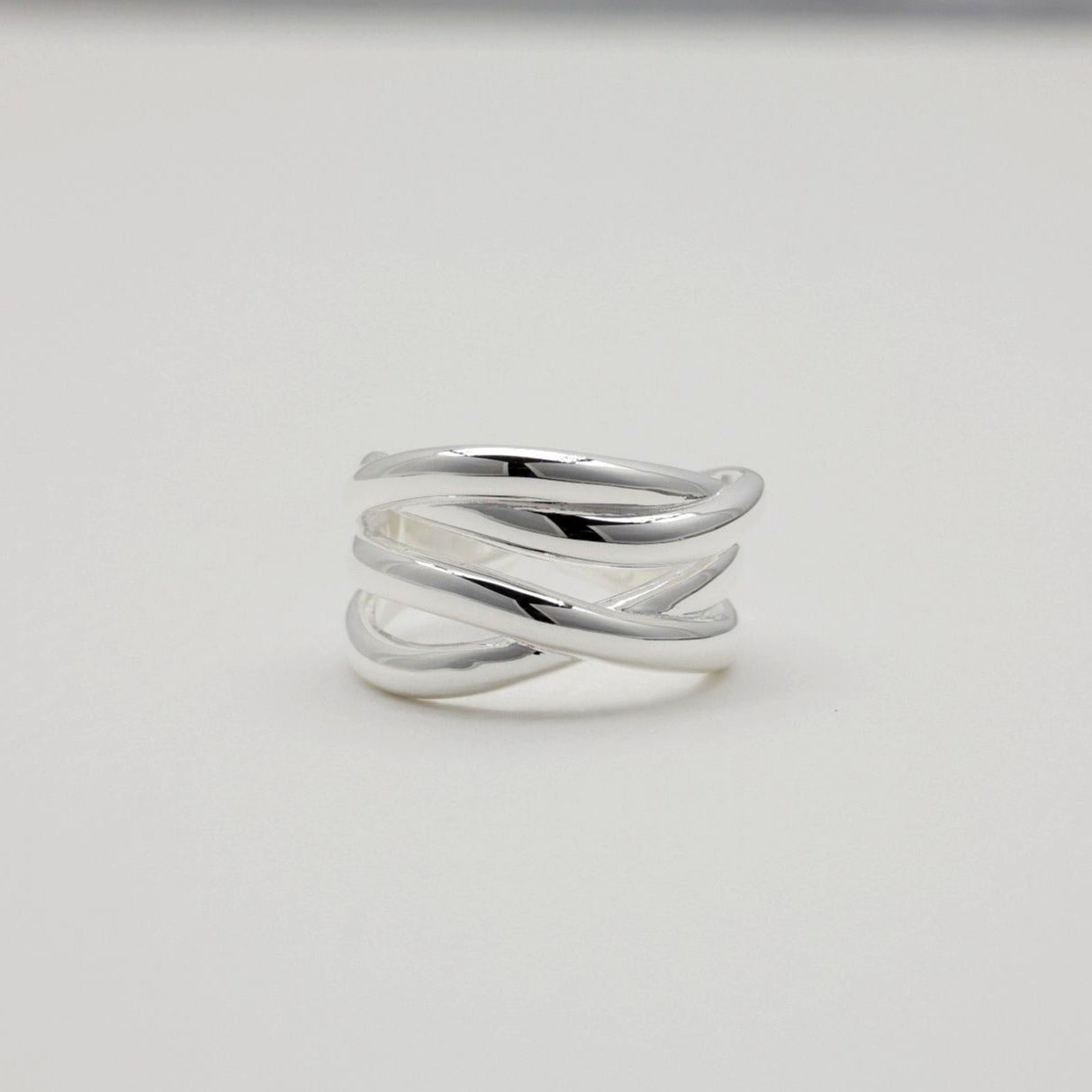 "Triple crossover ring in polished 925 sterling silver with open back"