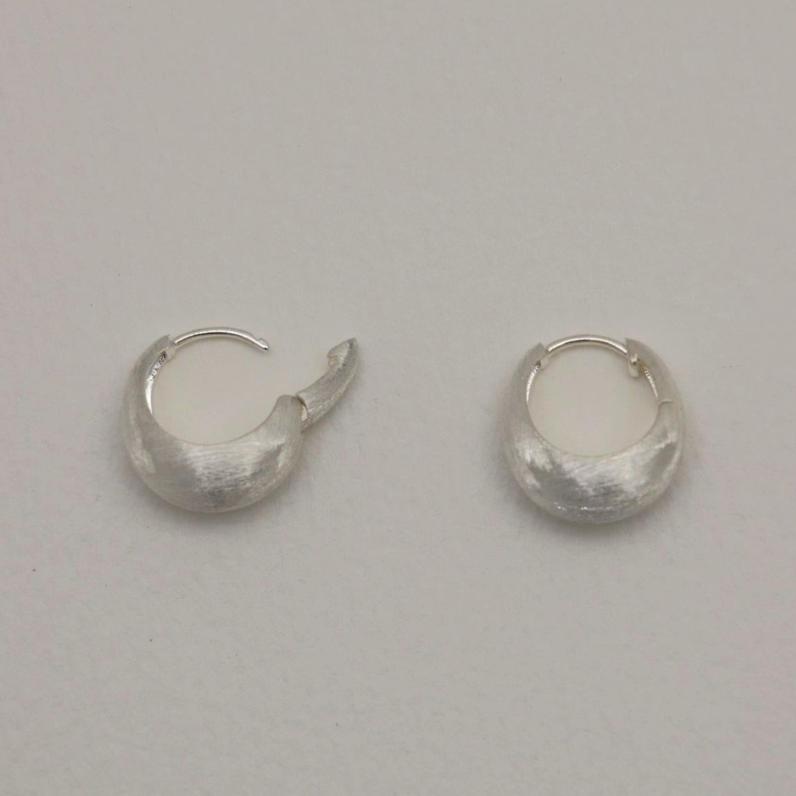 Sterling silver mini hoops with soft brushed finish