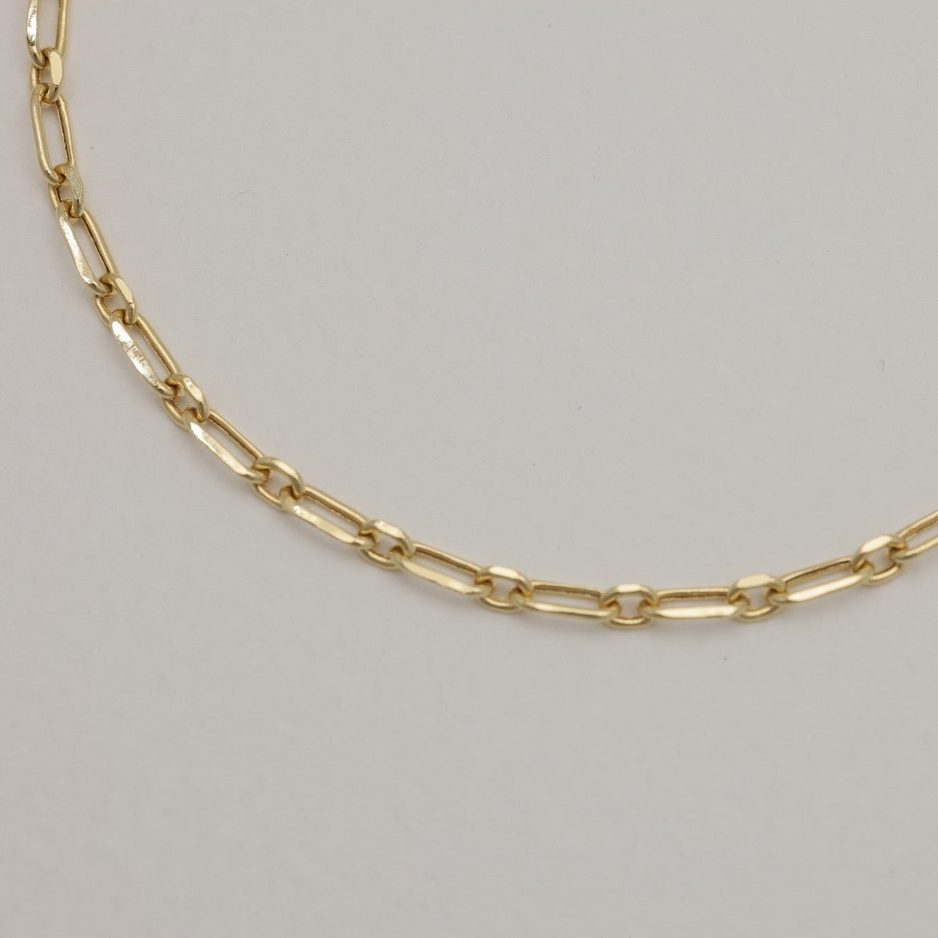 Close-up of spring clasp and extender on 18K gold chain bracelet