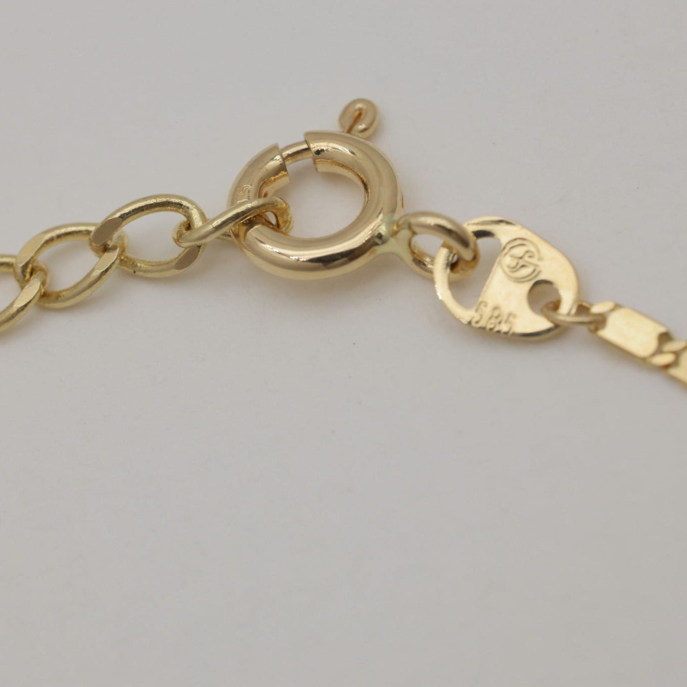 Side view of adjustable chain bracelet in 14K gold with clasp visible.