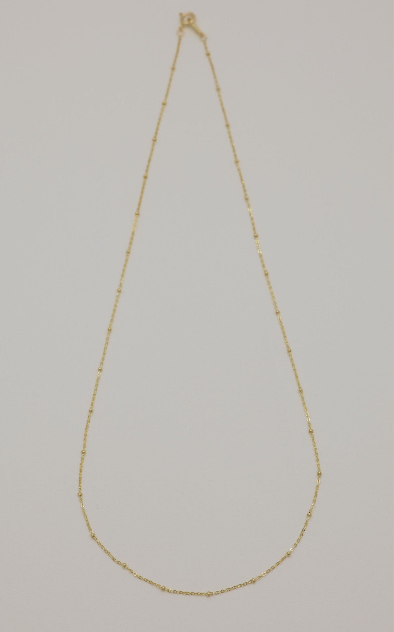 Full view of Maëlle 14K gold necklace with delicate bead accents
