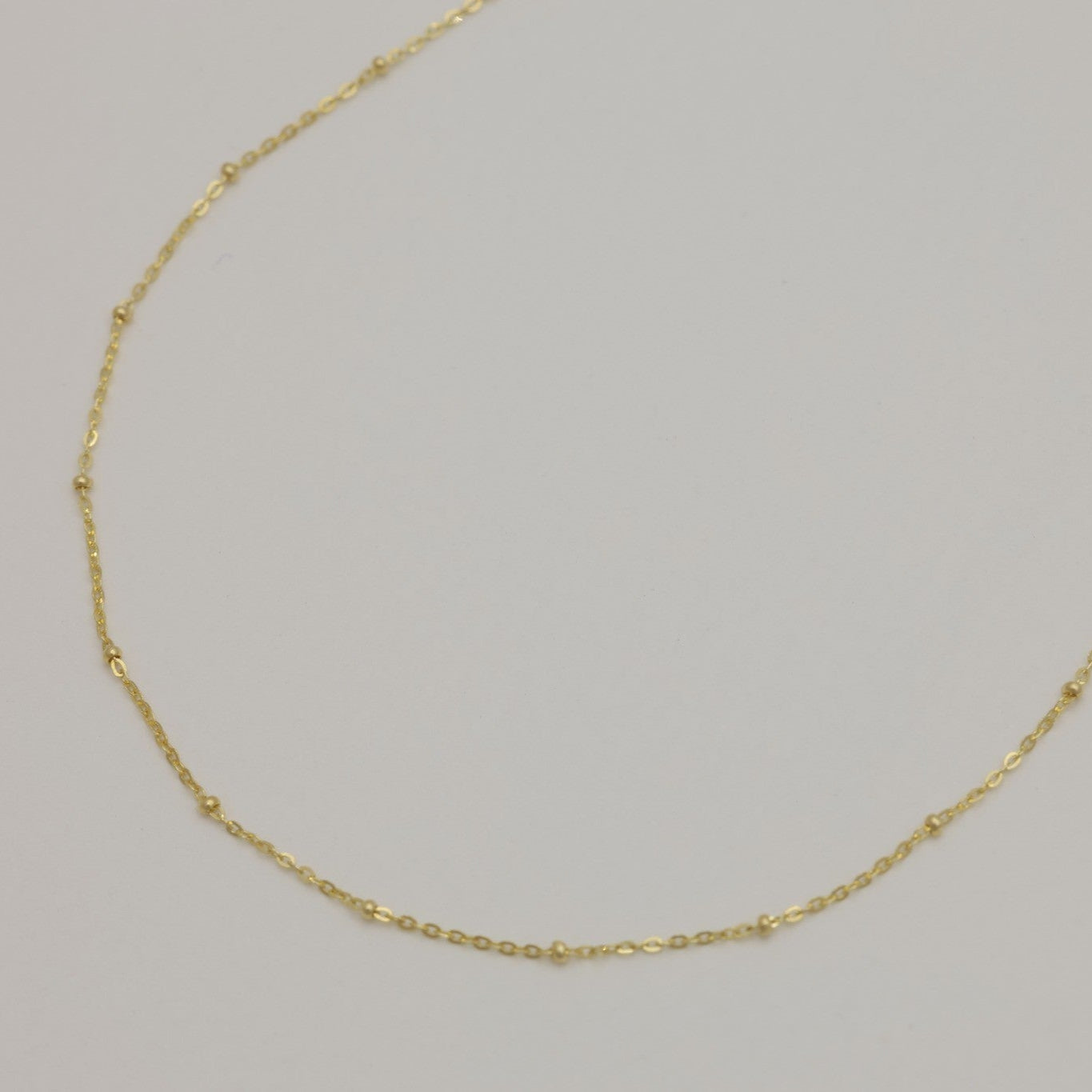 Side angle showing soft curved links and polished finish