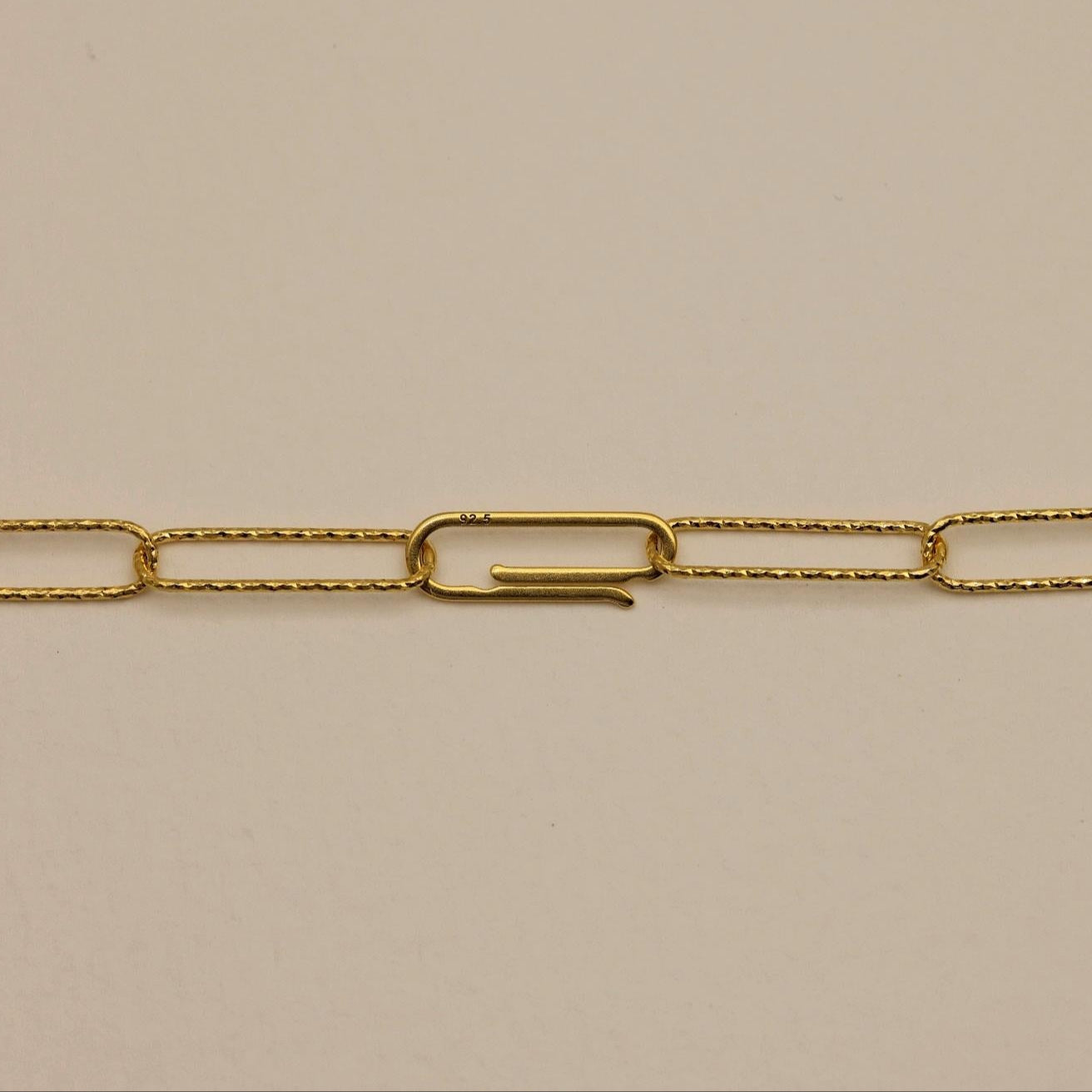 Close-up of the unique 925-stamped hook clasp on a gold vermeil chain necklace.