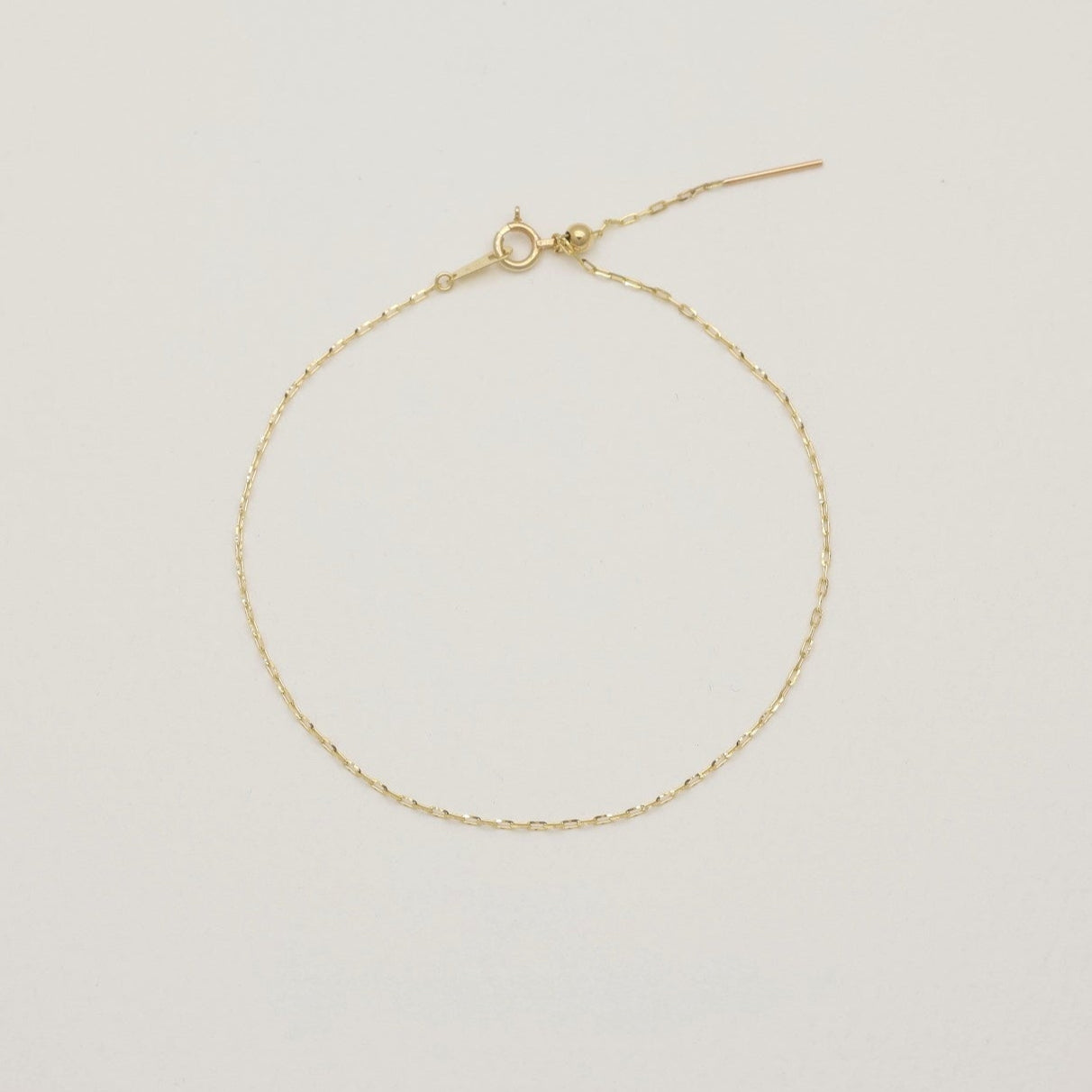 Mireille Chain Bracelet in 10K Gold laid flat showing full chain loop on neutral background