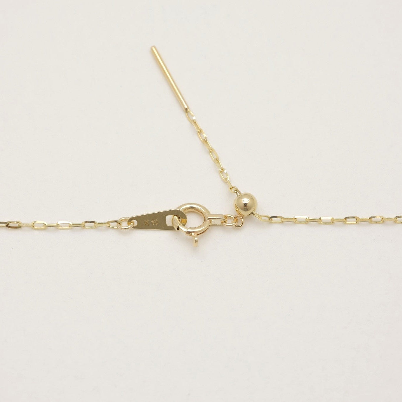 Close-up of adjustable clasp and tag marked K10 on Mireille Chain Bracelet