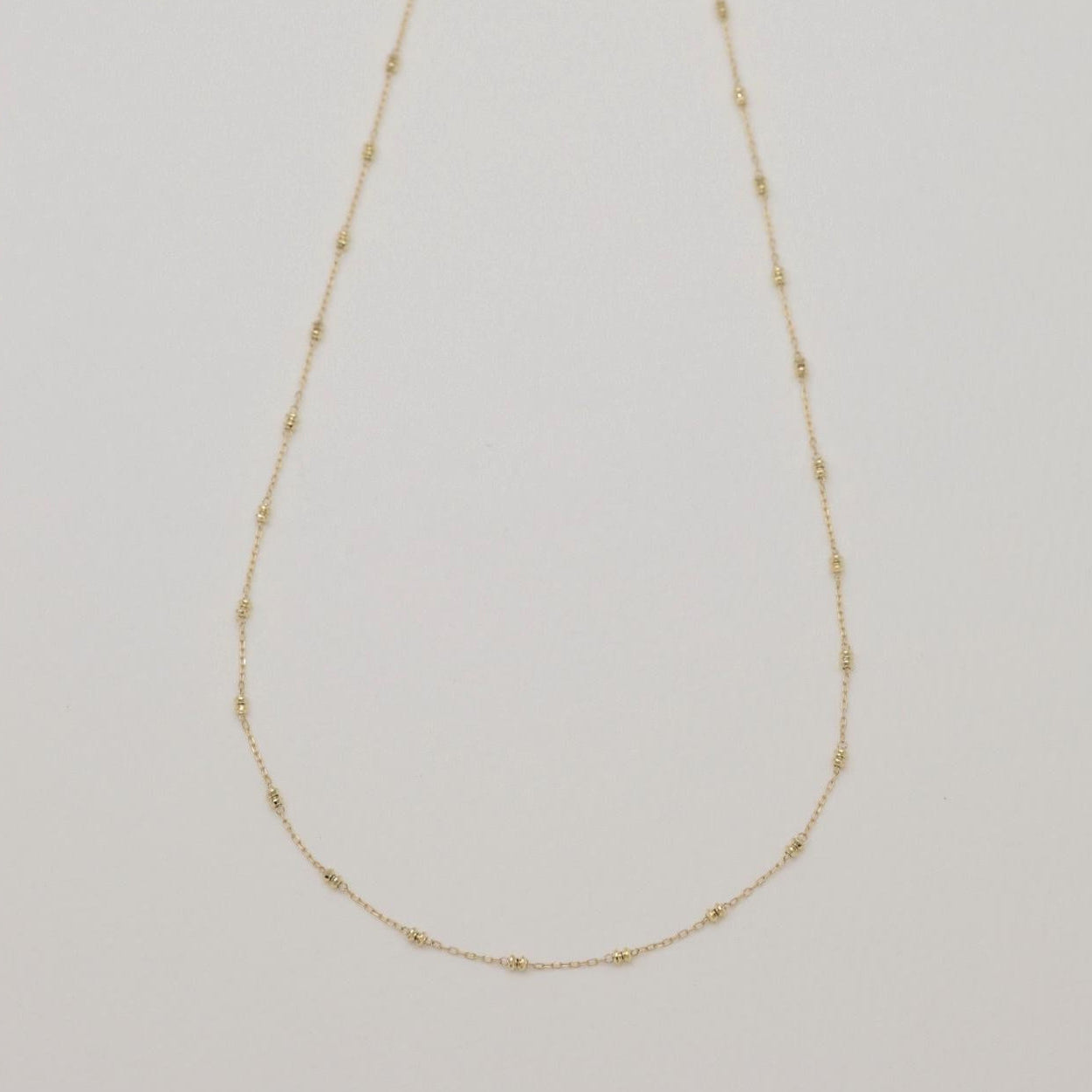 Delicate satellite gold necklace with minimalist detailing