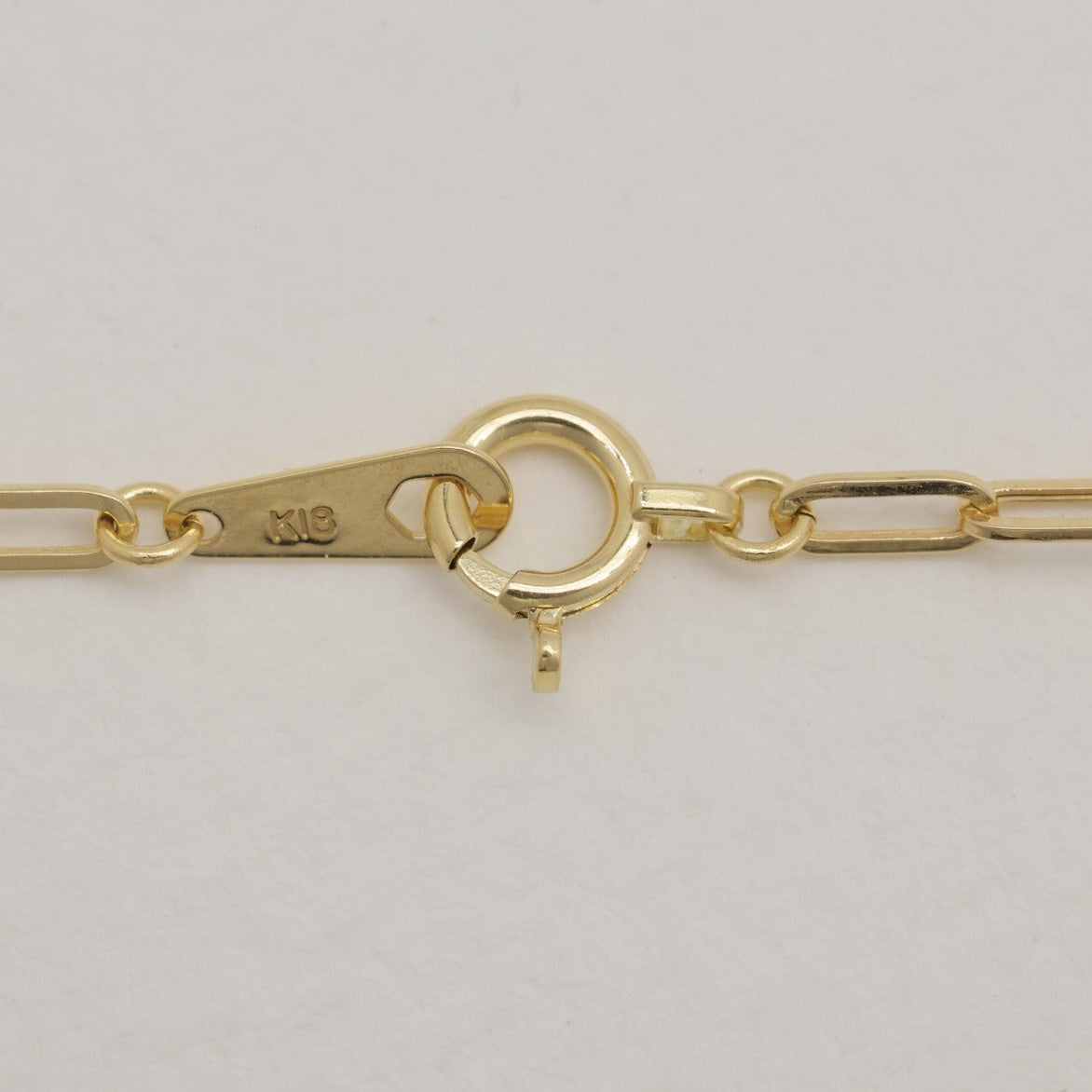 Macro close-up of links and clasp stamped K18