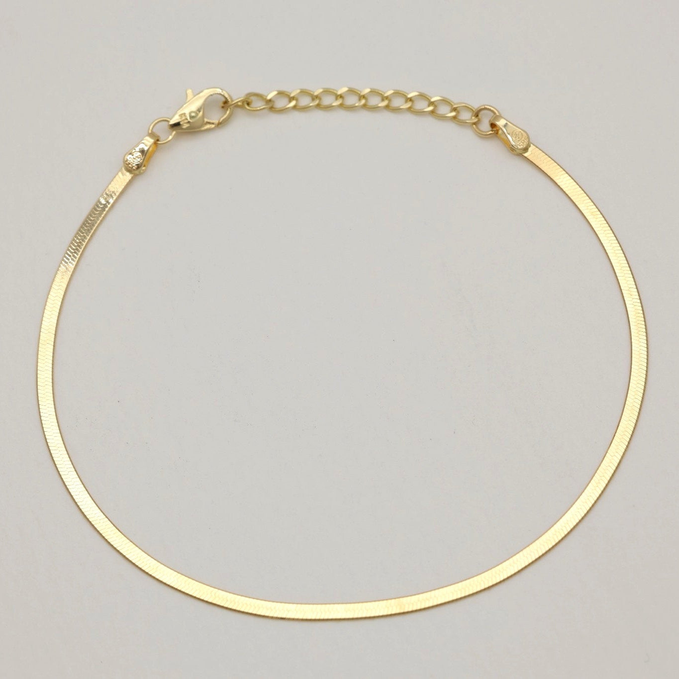 Side view of 14K gold bracelet highlighting flexible snake chain design