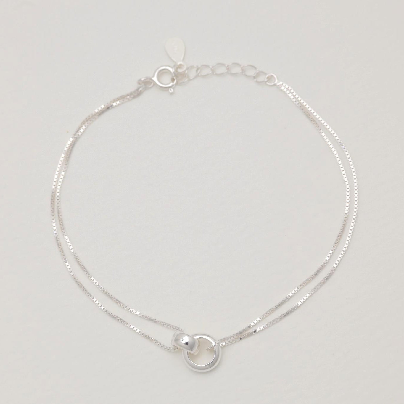 Flat lay view of the Liliane bracelet fully extended, highlighting the twin box chains and extender clasp.