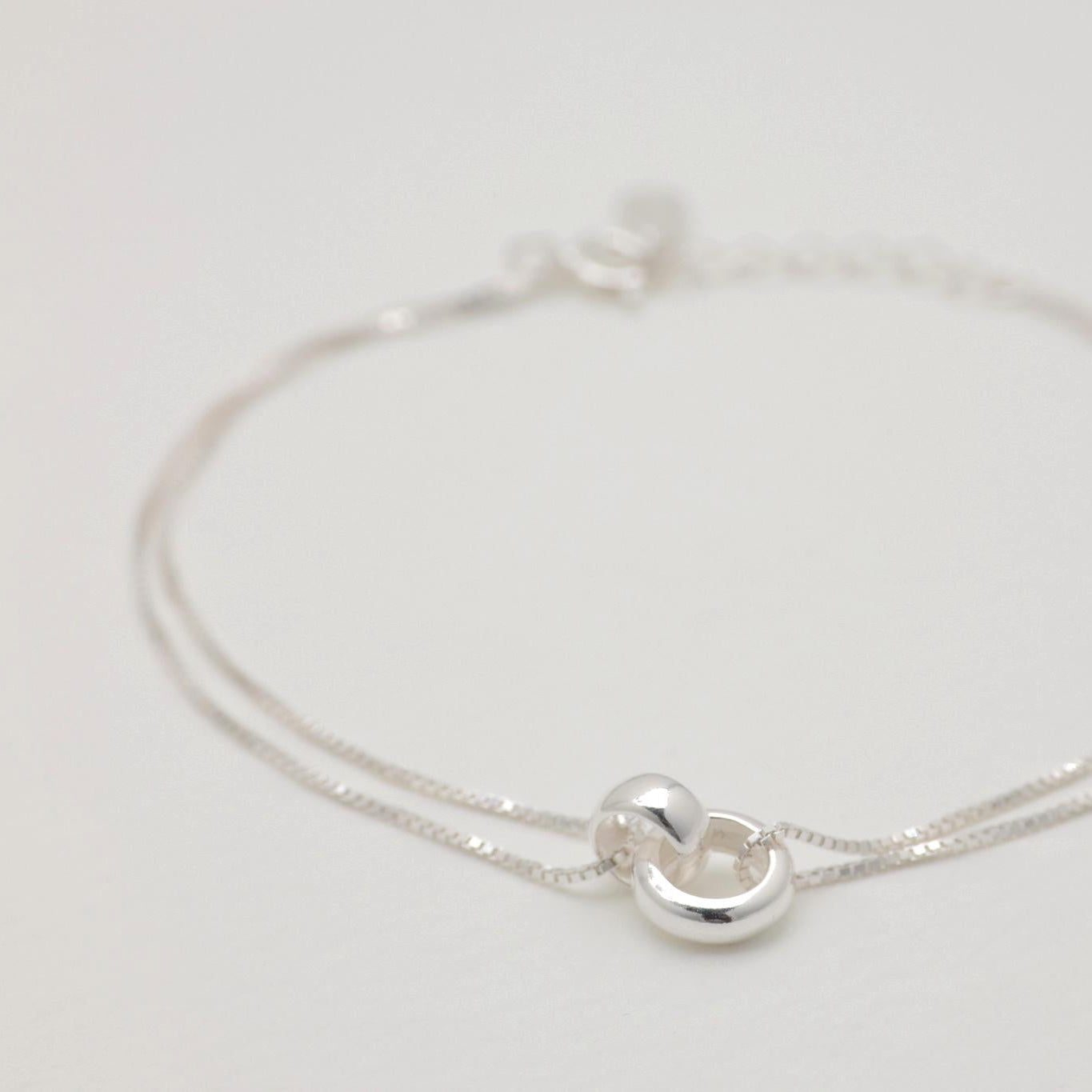 Alternate angled view showing the smooth finish and sculptural charm of the Liliane Double Chain Bracelet.