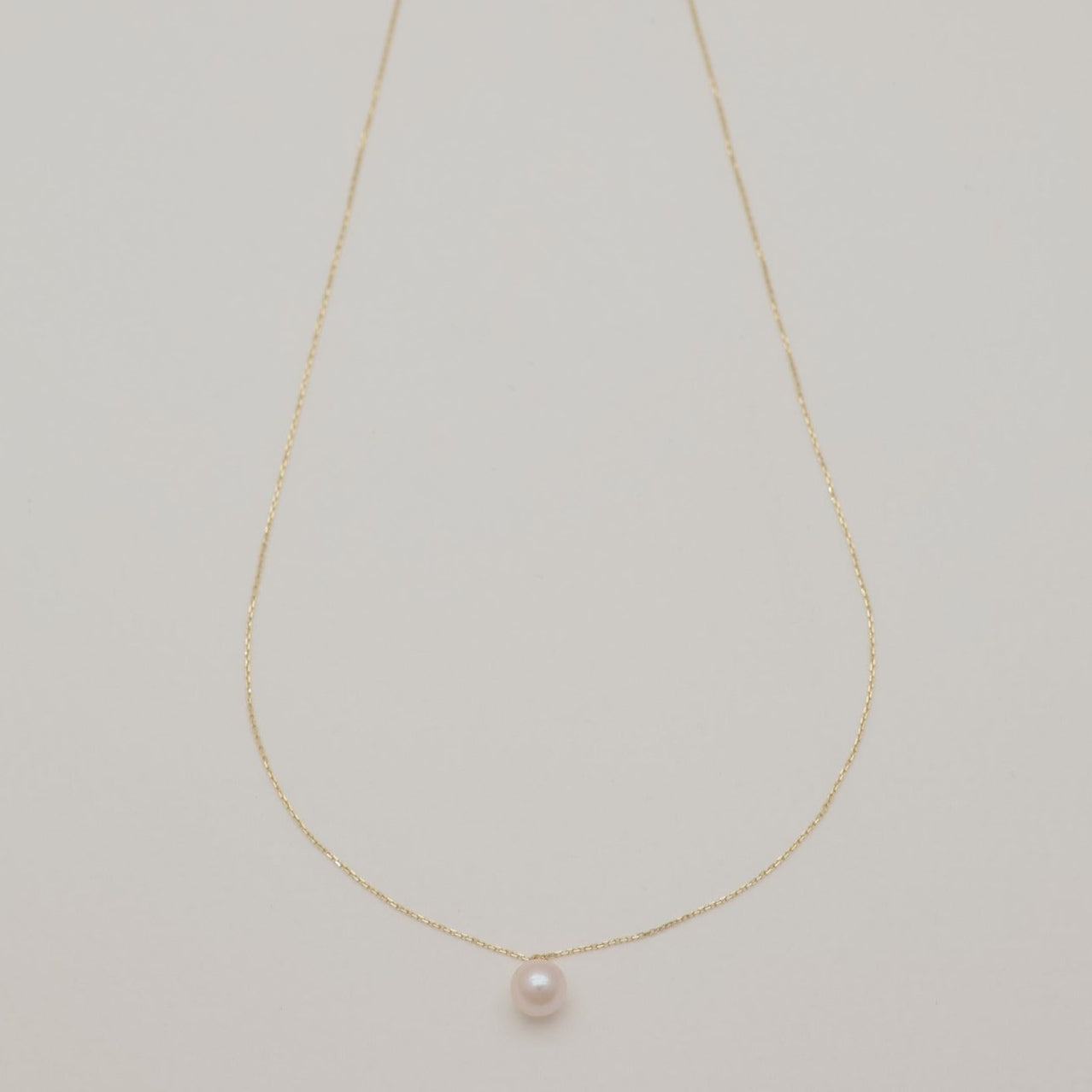 Full-length view of the Sophie necklace featuring a single Akoya pearl on a fine 10K gold chain.