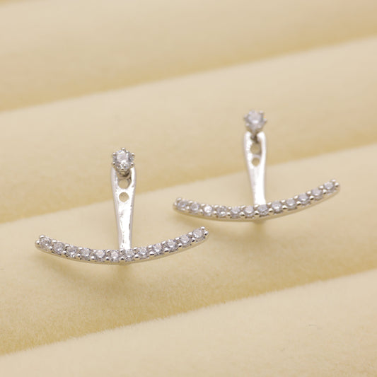 Sterling silver convertible earrings with cubic zirconia arc design on cream background.