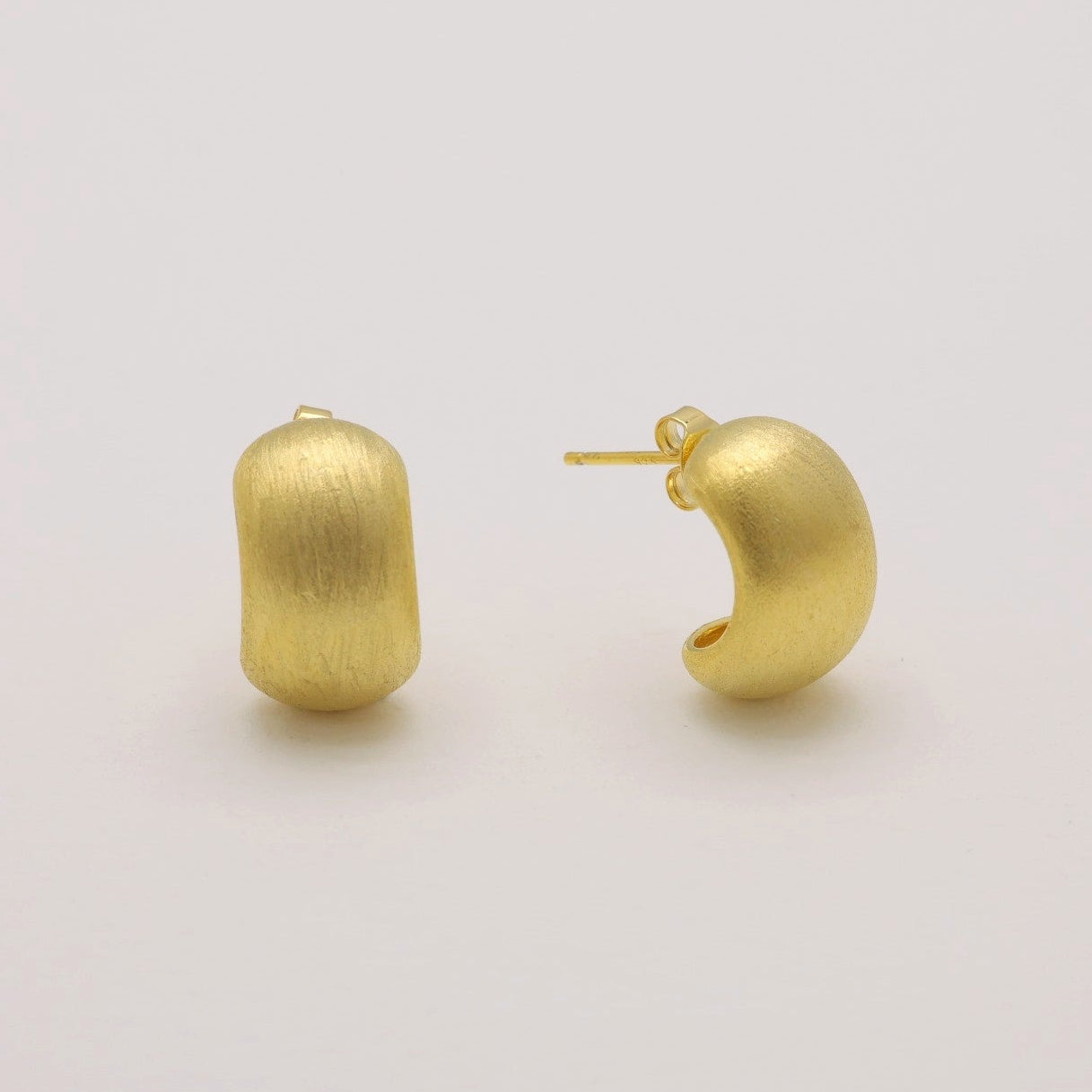 Matte brushed gold vermeil hoop earrings on neutral background, front angle