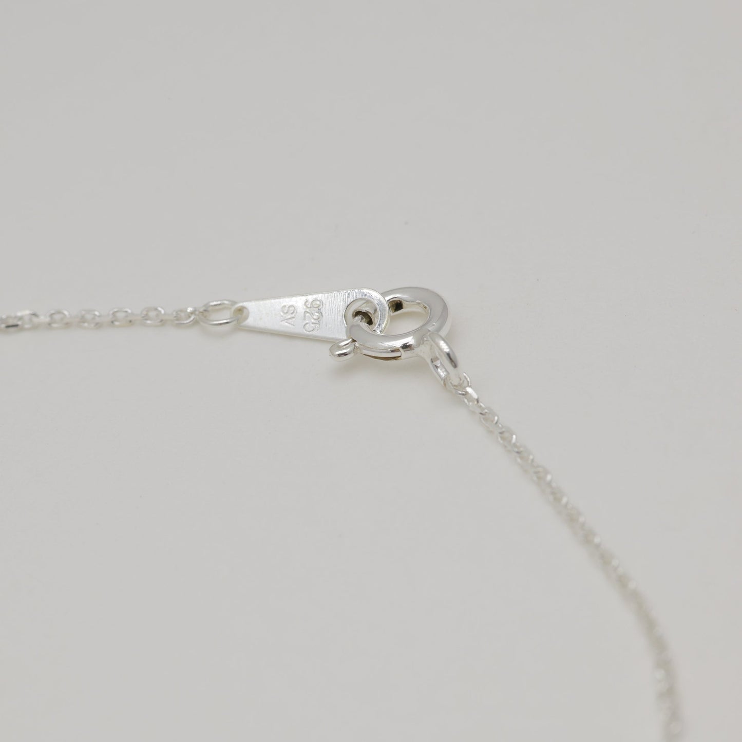 Sterling silver necklace clasp and hallmark detail.